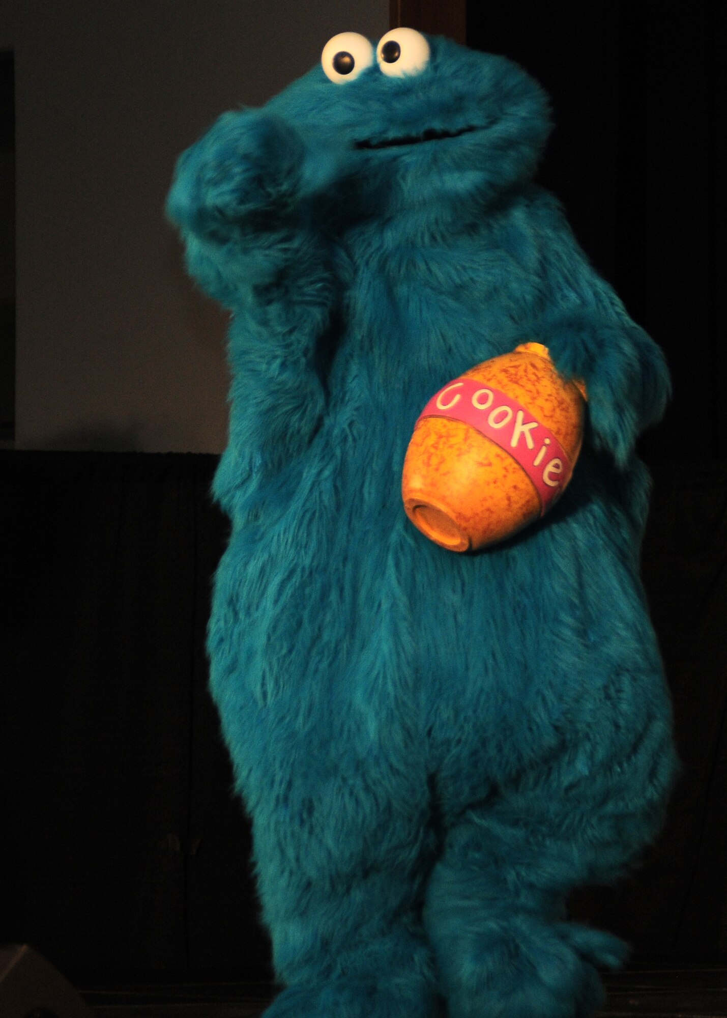 Yokota AB, Japan -- Cookie Monster, a Sesame Street character, tries to open a cookie jar during a USO sponsored Sesame "Talk, Listen, Connect" performance, Jan. 16 at the Taiyo Community Center. (U.S Air Force photo/Airman 1st Class Katrina Menchaca)