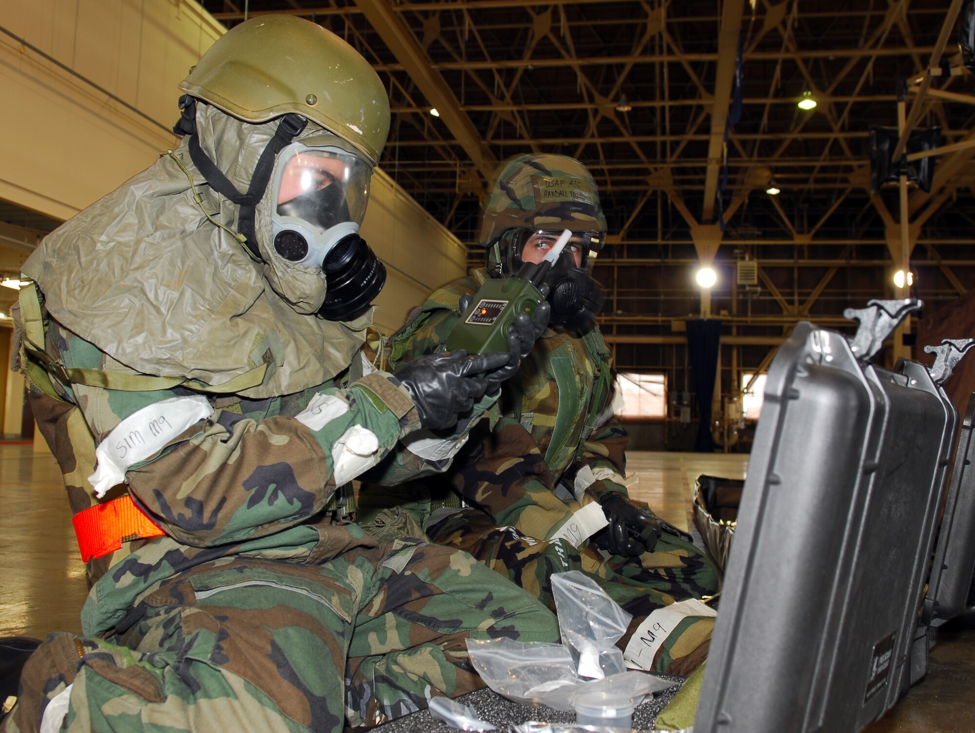 MISAWA AIR BASE, Japan--Airmen 1st Class David Angles and Randall Summers, prepare Joint Chemical Agent Detection equipment during a contamination control area exercise Jan. 21 in Hangar 949. The JCAD system is a new piece of equipment fielded to replace older equipment. Airman Angles is assigned to the 14th Aircraft Maintenance Squadron and Airman Summers is assigned to the 35th Communications squadron. (U.S. Air Force photo/Staff Sgt. Phillip Butterfield)