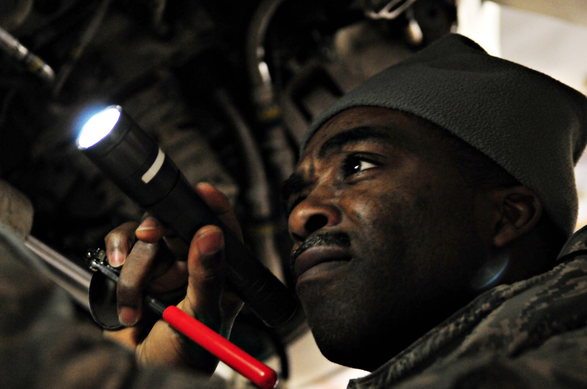 SPANGDAHLEM AIR BASE, Germany -- Tech Sgt. Deke Stacy, 52nd Fighter Wing exercise evaluation team member, inspects panels on an F-16 Fighting Falcon as part of aircraft generation during Operation Saber Crown 10-3. EET members check to see that the aircrew and pilot complete all necessary steps for the aircraft to be deployed. (U.S. Air Force photo/Staff Sgt. Heather M. Norris)