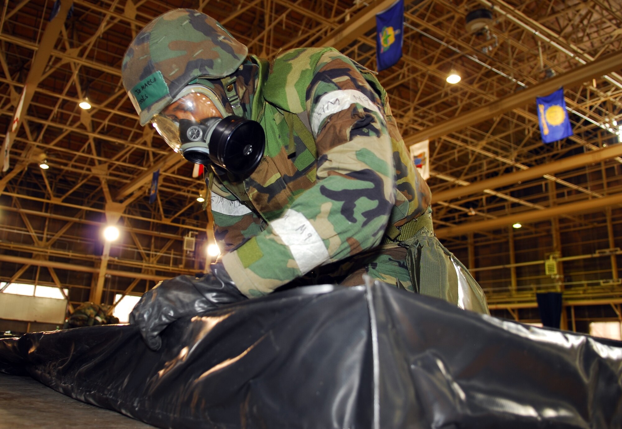 MISAWA AIR BASE, Japan--Airman 1st Class Jemarco Brooks, 35th Logistics Readiness Squadron fuels flight technician, builds a rigid ground tarp during a contamination control area exercise Jan. 21 in Hangar 949. Airmen from the 35th LRS, 35th Aircraft Maintenance Squadron, 35th Maintenance Squadron, 35th Comptroller Squadron and the 35th Communications Squadron participated in the exercise. (U.S. Air Force photo/Staff Sgt. Phillip Butterfield)