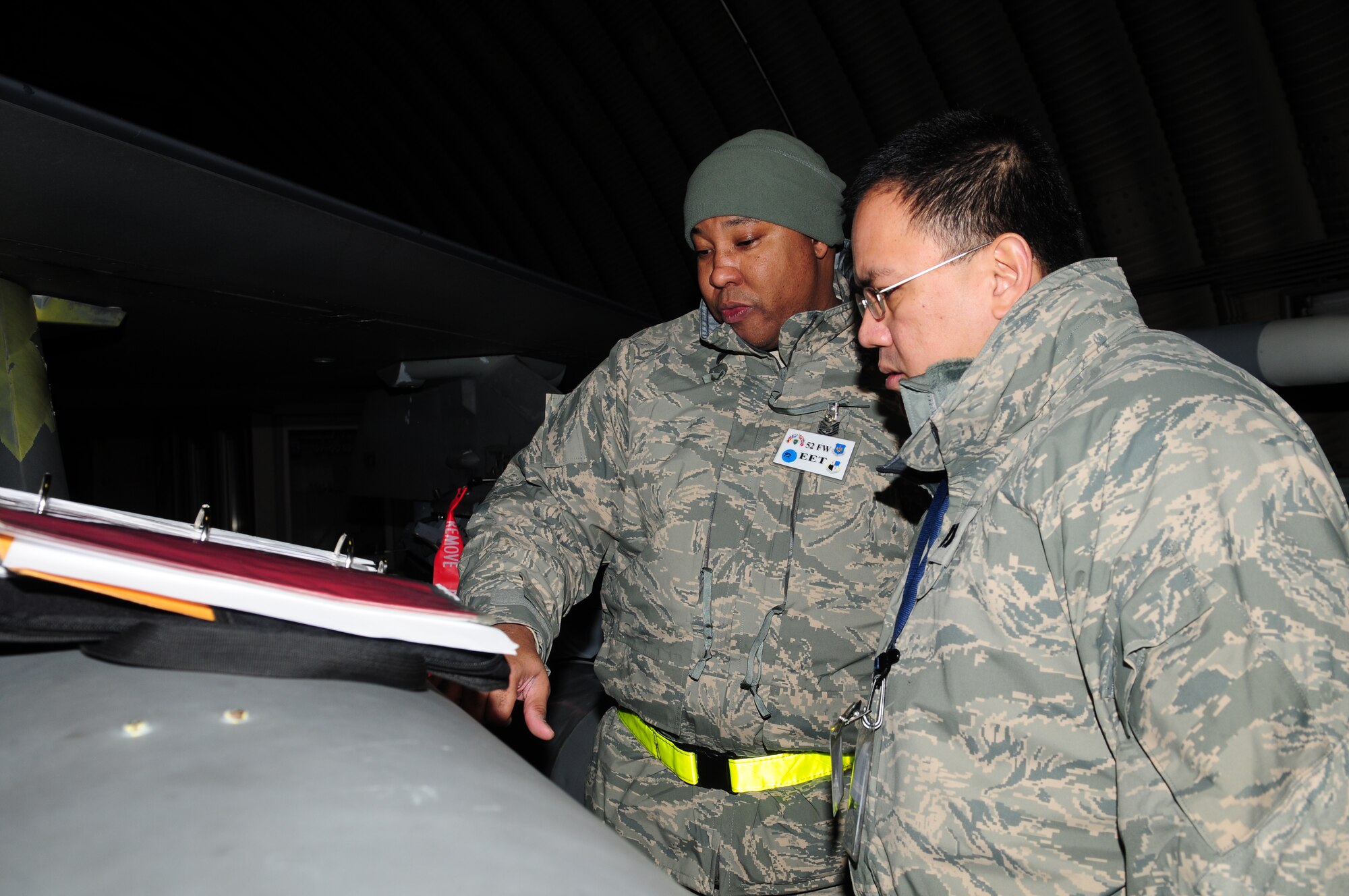 SPANGDAHLEM AIR BASE, Germany -- Master Sgt. Marlon Bell and Capt. Angelo Sta Agueda , both 52nd Fighter Wing exercise evaluation team members,  evaluate a pregeneration flow chart on an F-16 Fighting Falcon Jan. 20. Pregeneration allows aircraft to be prepped and ready to deploy in a timely manner. (U.S. Air Force photo/Staff Sgt. Heather M. Norris)