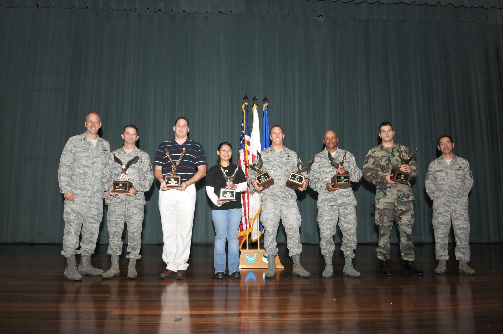 KADENA AIR BASE, Japan -- Col. Robert Toth (far left), 353rd Special Operations Group commander, and Chief Master Sgt. Frank Robertson (far right), acting 353rd SOG command chief master sergeant, pose for a photograph with the group's 2009 annuals awards winners Jan. 22. The winners are, from left: Master Sgt. Steven Erickson, James D'Angina, Irene Jones, Maj. Jason Self, accepting for Capt. Garrett Ianacone and Staff Sgt. William Johnson, Master Sgt. Anthony Duplechain, and Senior Airman Salvatore Portelli. (Photo by Tech. Sgt. Aaron Cram)