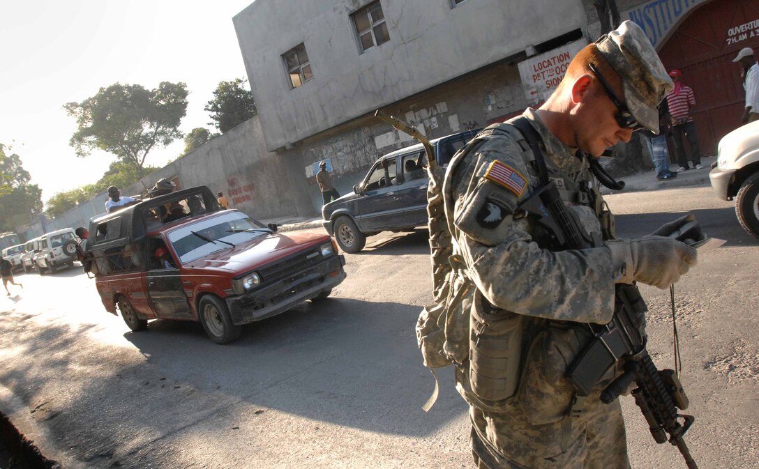 U.S. Army Staff Sgt. Joey Brumfield checks his global positioning system as he looks for a local hospital in Port-au-Prince, Haiti, Jan. 20, 2010. Brumfield is assigned to the 82nd Airborne Division's 1st Squadron, 73rd Cavalry Regiment, which is fanning out into the local area to see what assets are available and what the community needs. 
