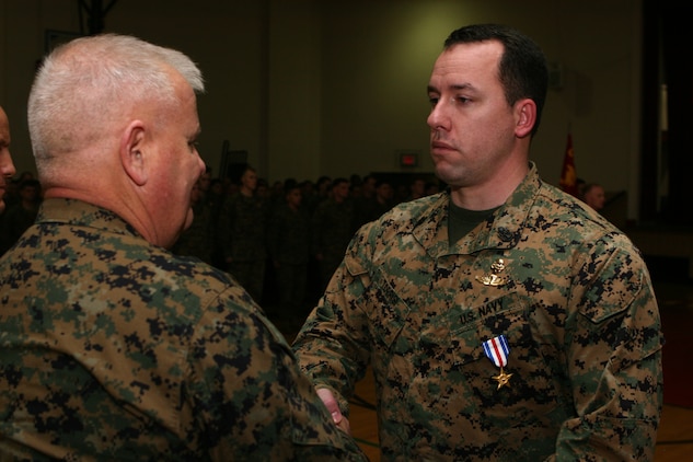 Maj. Gen. Paul E. Lefebvre,  the commander of U.S. Marine Corps Forces Special Operations Command presents Chief Petty Officer Jeremy K. Torrisi, a hospital corpsman with 2d Marine Special Operations Battalion with the Silver Star Medal in Court House Bay's gymnasium, Jan 21. Torrisi recieved the medal for heroic actions ni Afghanistan on June 26. 2008