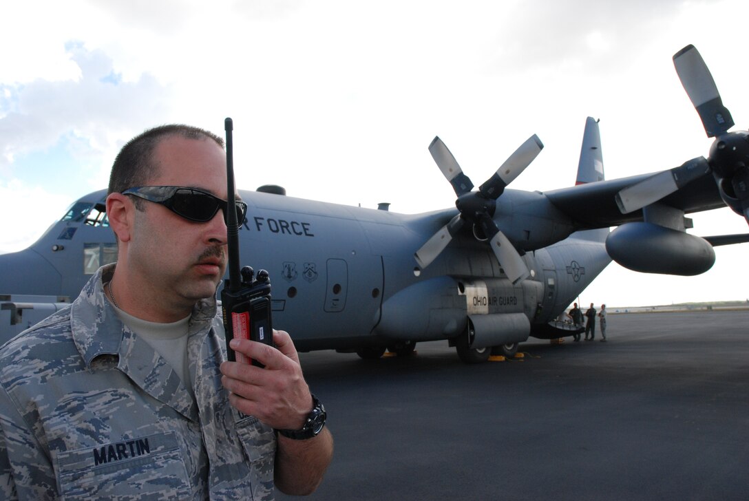 Master Sgt. Heath Martin, 94th Maintenance crew chief from Dobbins Air Reserve Base, Ga., provides transient alert support to Operation Unified Response aircraft at Homestead Air Reserve Base, Fla.  
"Master Sgt. Johnny Vincent and I have assisted with the marshalling of more than 282 aircraft here," said Sergeant Martin. 
Various airlift aircraft, including Air Force Reserve Command and Air National Guard C-130s have supported the Coronet Oak mission of providing disaster-relief airlift to the Republic of Haiti. (U.S. Air Force photo/Master Sgt. Stan Coleman)