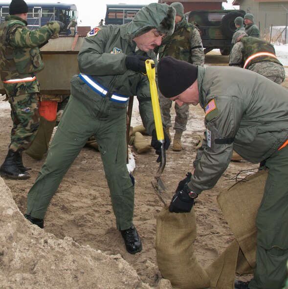 Colonel Carlos Quinones Commander 156th Airlift Wing, Puerto Rico Air National Guard and Colonel Greg A. Haase Commander 133rd Airlift Wing, Minnesota Air National Guard fill sand bags as part of the "base build up" portion of a Operational Readiness Exercise at Volk Field, Wisconsin January 23, 2010. An ORE provides the chance for units to identify and correct essential tasks for the  upcoming Operational Readiness Inspection.The other units involved along with the 133rd Airlift Wing are: the EOD from the 123rd Civil Engineering Squadron, Kentucky Air National Guard; the 94th Aerial Port Squadron, Dobbins Air Reserve Base, Ga.; the 156th Airlift Wing, Puerto Rico Air National Guard; and the 375th Air Mobility Wing, Scott AFB, Ill. All the units are preparing for a upcoming ORI in March 2010. U.S. Air Force photo/Tech Sgt. Erik Gudmundson