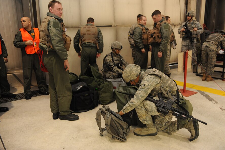 MINOT AIR FORCE BASE, N.D. -- Members of the 5th Security Forces Squadron conduct sercurity checks on crew member's bags and ID's prior to their aircraft acceptance procedures exercise here Jan. 20.  The crew members were evaluated by the Air Combat Command Inspector General team as part of the 5th Bomb Wing's no-notice inspection.