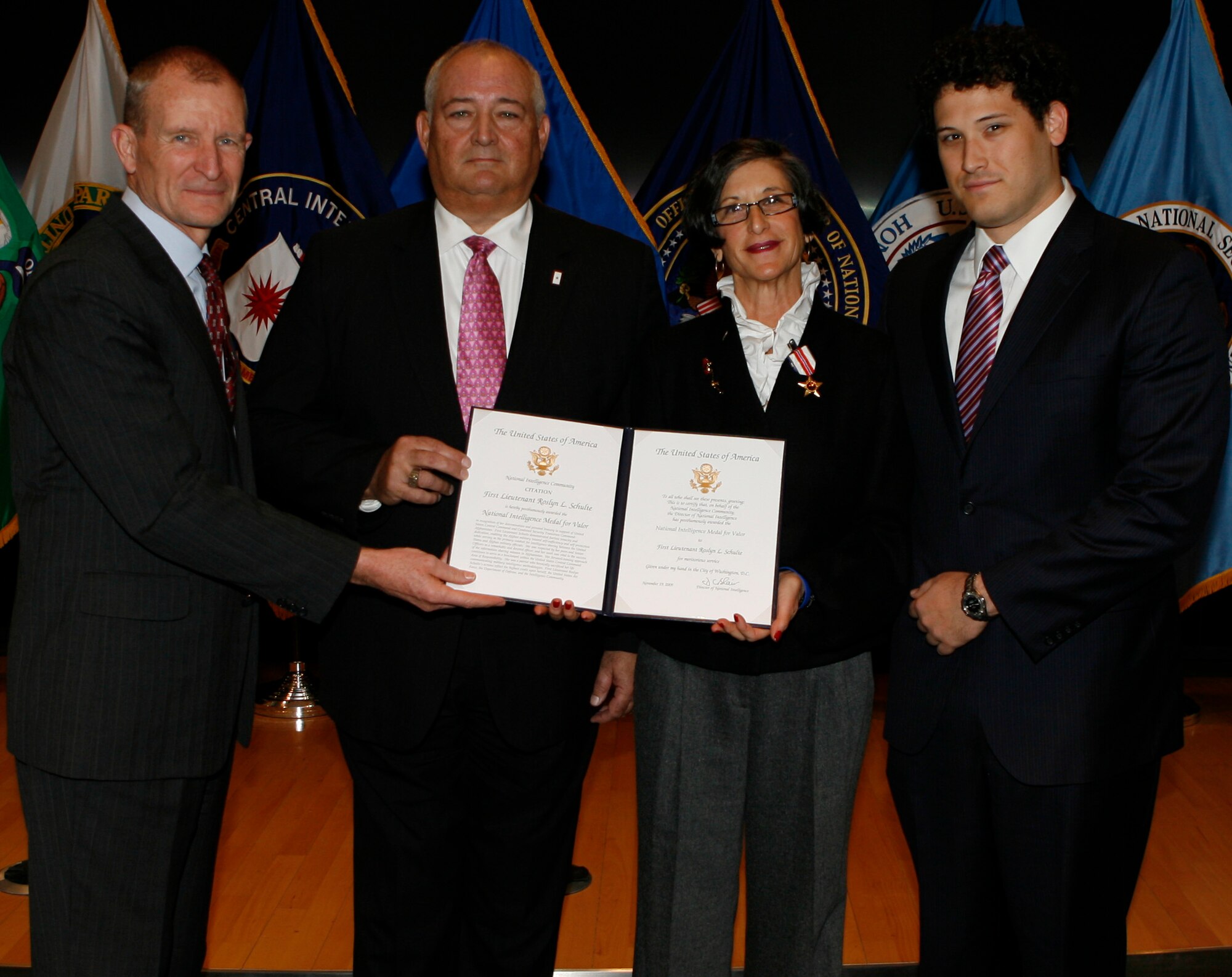 Director of National Intelligence Dennis C. Blair (left) stands with 1st Lt. Roslyn Schulte’s family during a ceremony Jan. 22 in which the Airman was posthumously awarded the National Intelligence Medal for Valor.  Lieutenant Schulte’s parents, Robert and Susie (center), and her brother, Todd (right), attended the event on her behalf. (Courtesy photo)