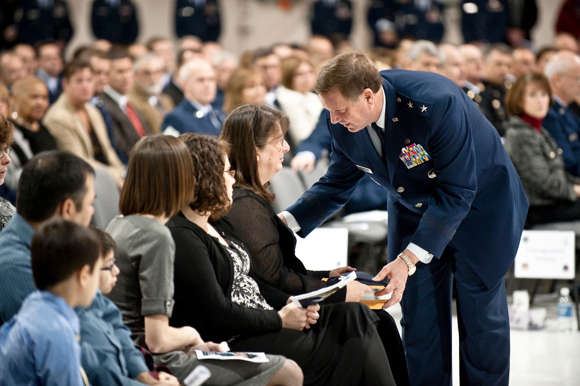 Kentucky's adjutant general, Maj. Gen. Edward Tonini, presents the flag of the Commonwealth of Kentucky to Janet Bogusz Downs during a memorial service for her husband, 123rd Airlift Wing Command Chief Master Sgt. Tommy Downs, at the Kentucky Air National Guard Base Dec. 17. Chief Downs, a 31-year veteran of the Kentucky Air Guard, died Dec. 12 from complications of pancreatitis. More than 500 people attended the memorial service. (U.S. Air Force photo by Maj. Dale Greer)