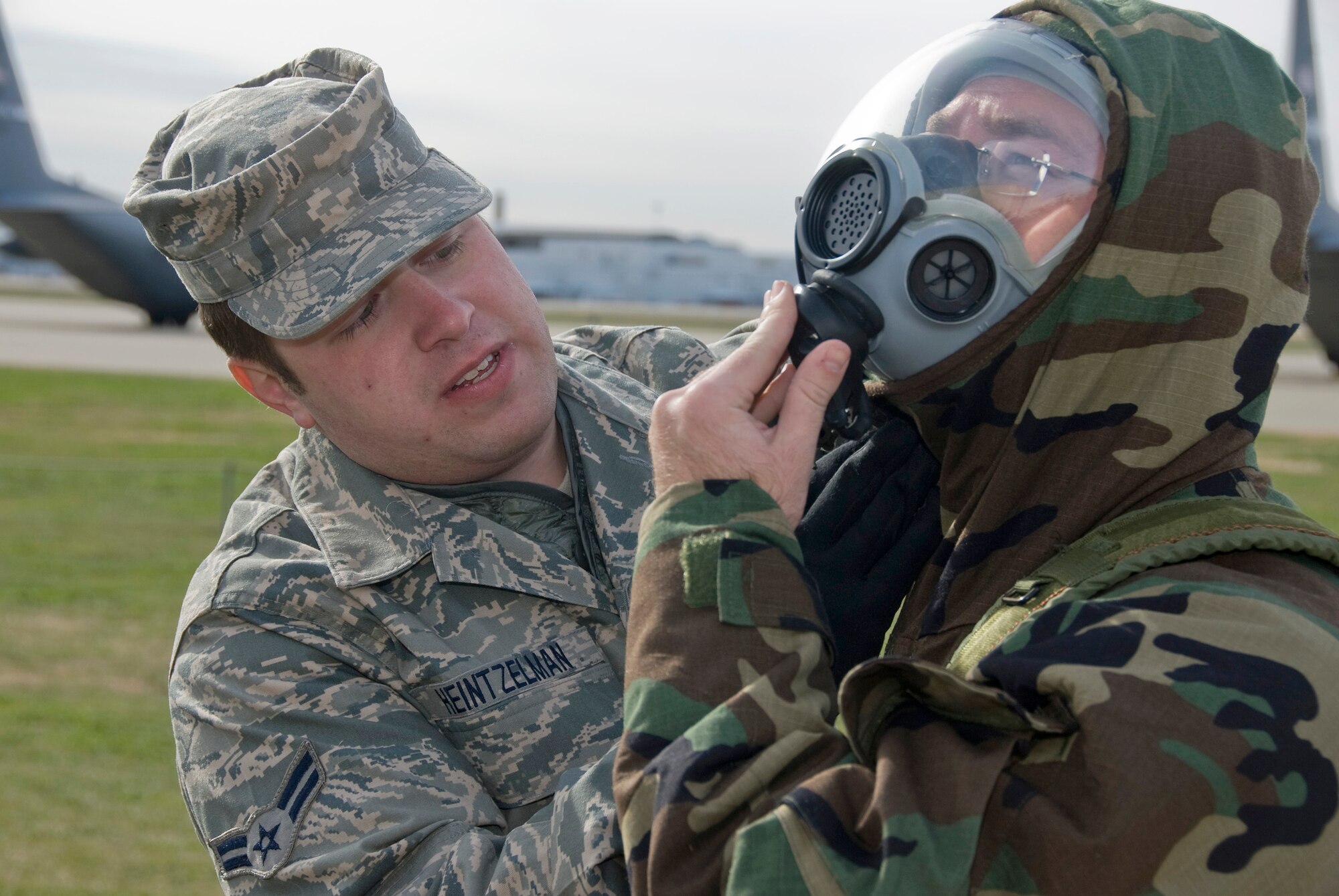 Airman 1st Class Zach Heintzelman of the 126th Air Refueling Wing, Scott Air Force Base, Ill., demonstrates how to properly don a gas mask during ATSO training at the Kentucky Air National Guard Base in Louisville, Ky., on Dec. 12, 2009. (United States Air Force by Senior Airman Maxwell Rechel)