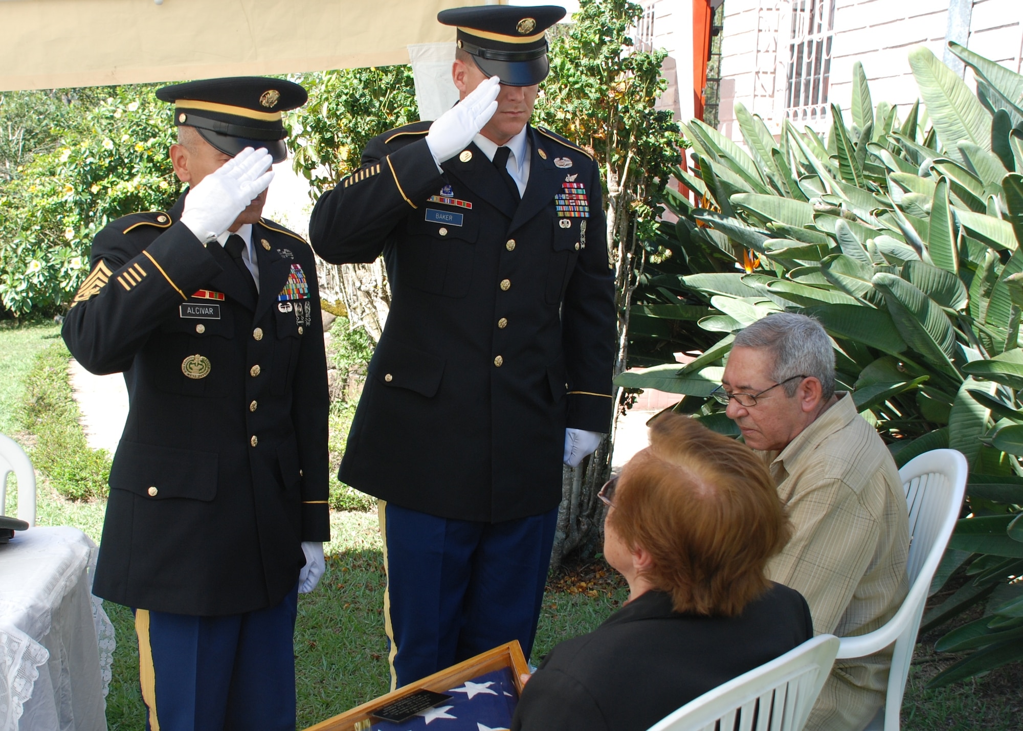 Command Sgt. Maj. Eloy Alcivar, Joint Task Force-Bravo Command Sergeant Major, and First Sgt. Mark Baker, 1/228th Aviation Regiment First Sergeant, salute Delia Soto, the Honduran mother of a fallen U.S. Soldier, during a memorial ceremony in Siguatepeque, Honduras, Jan 23. Danilo Soto, Jr. (Feb. 18, 1946 - Nov. 15, 2009) was an American citizen and Vietnam War veteran who served in the U.S. Army from 1966 to 1968. (U.S. Air Force photo by 1st Lt. Jen Richard)