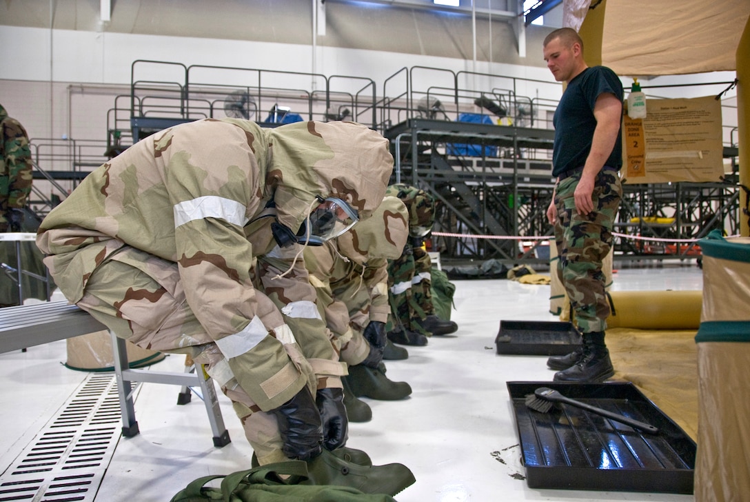 Airmen prepare to enter a decontamination station after exposure to simulated chemical agents during at ASTO exercise in the Main Hangar of the Kentucky Air National Guard Base in Louisville, Ky., on Dec. 12, 2009. (United States Air Force by Senior Airman Maxwell Rechel)