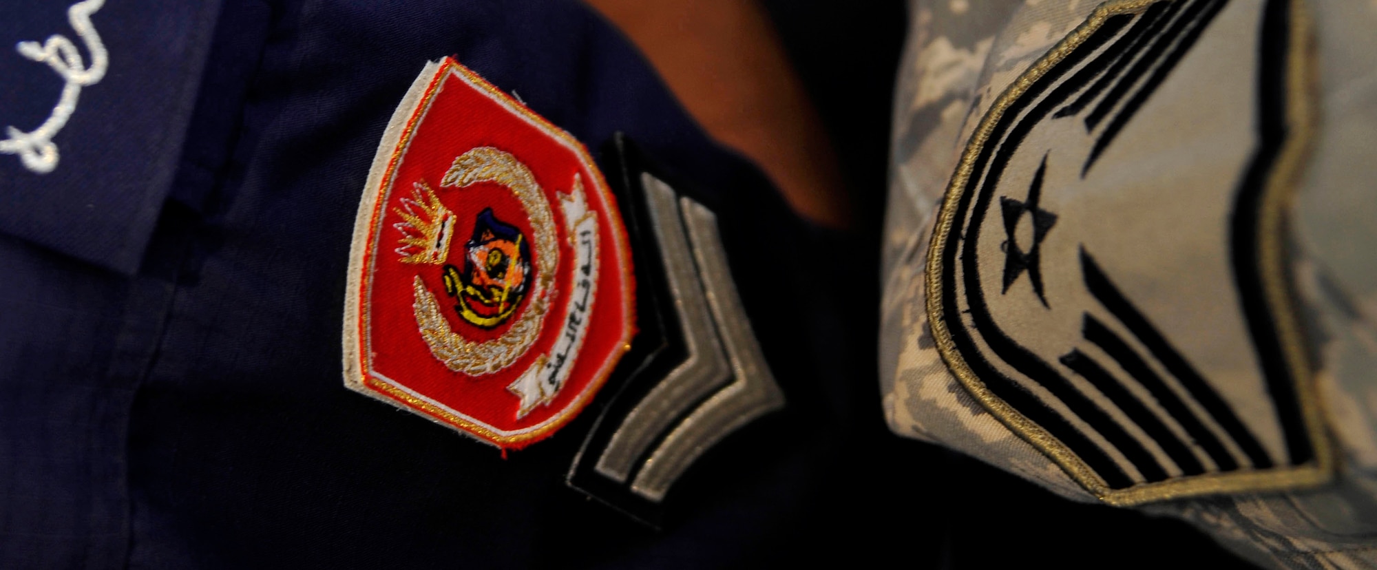 A U.S. Air Force Airman and a Bahraini civil defense force member, speak about emergency-response techniques during Bahrain's inaugural airshow, Jan. 23, 2010.   They discussed techniques for emergency action. (U.S. Air Force photo/ Staff Sgt. Angelita Lawrence/released)

