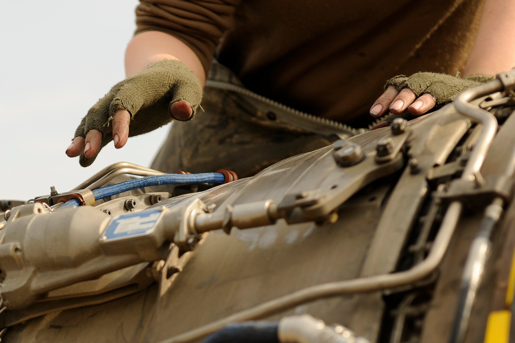 BAGRAM AIRFIELD, Afghanistan--U.S. Air Force Staff Sgt. Kelly Kollmar, 455th Expeditionary Aircraft Maintenance Squadron, repairs an F-15E engine on Bagram Airfield Jan. 23, 2010. Kollmar is deployed from Royal Air Force Station Lakenheath, England, and is from Buffalo, N.Y. (U.S. Air Force photo by: Tech. Sgt. Jeromy K. Cross/released)


