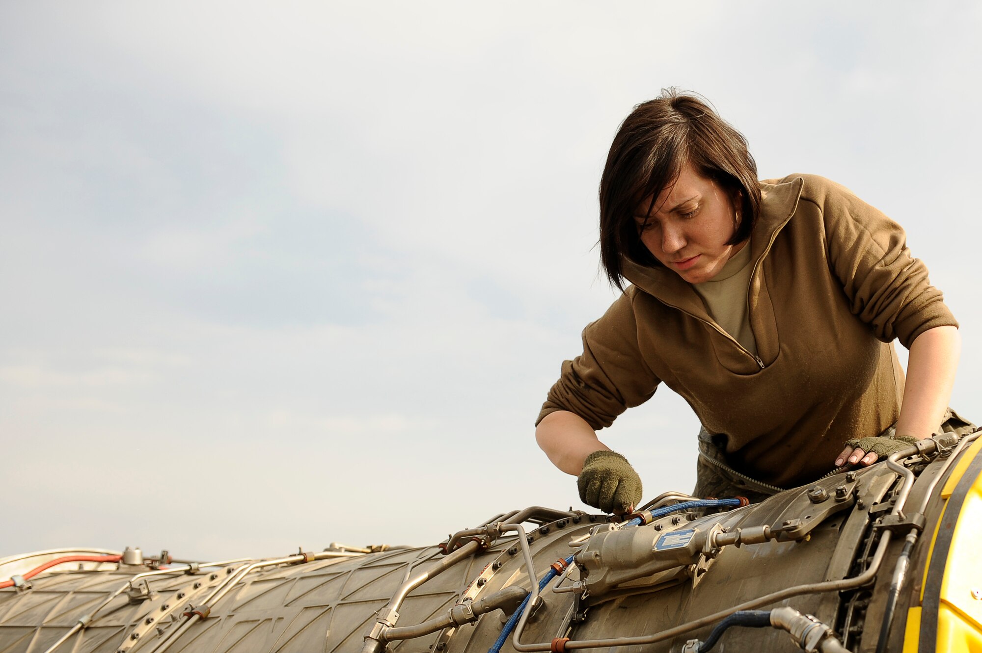 BAGRAM AIRFIELD, Afghanistan--U.S. Air Force Staff Sgt. Kelly Kollmar, 455th Expeditionary Aircraft Maintenance Squadron, repairs an F-15E engine on Bagram Airfield Jan. 23, 2010. Kollmar is deployed from Royal Air Force Lakenheath, England, and is from Buffalo, N.Y. (U.S. Air Force photo by: Tech. Sgt. Jeromy K. Cross/released)

