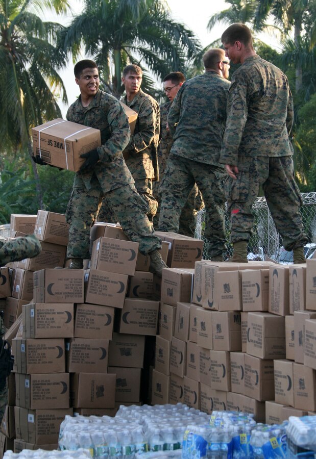 Marines from Combat Logistics Battalion 22, 22nd Marine Expeditionary Unit, load a 7-ton truck with relief supplies for distribution in Petit Goave, Haiti Jan. 24, 2010. In response to a devastating earthquake, which struck the country of Haiti, Marines and sailors of the 22nd MEU began to deliver relief supplies and providing medical aid in support of Operation Unified Response, Jan 19, 2010.::r::::n:: (Official Marine Corps photo by: Cpl. Theodore W. Ritchie)::r::::n::