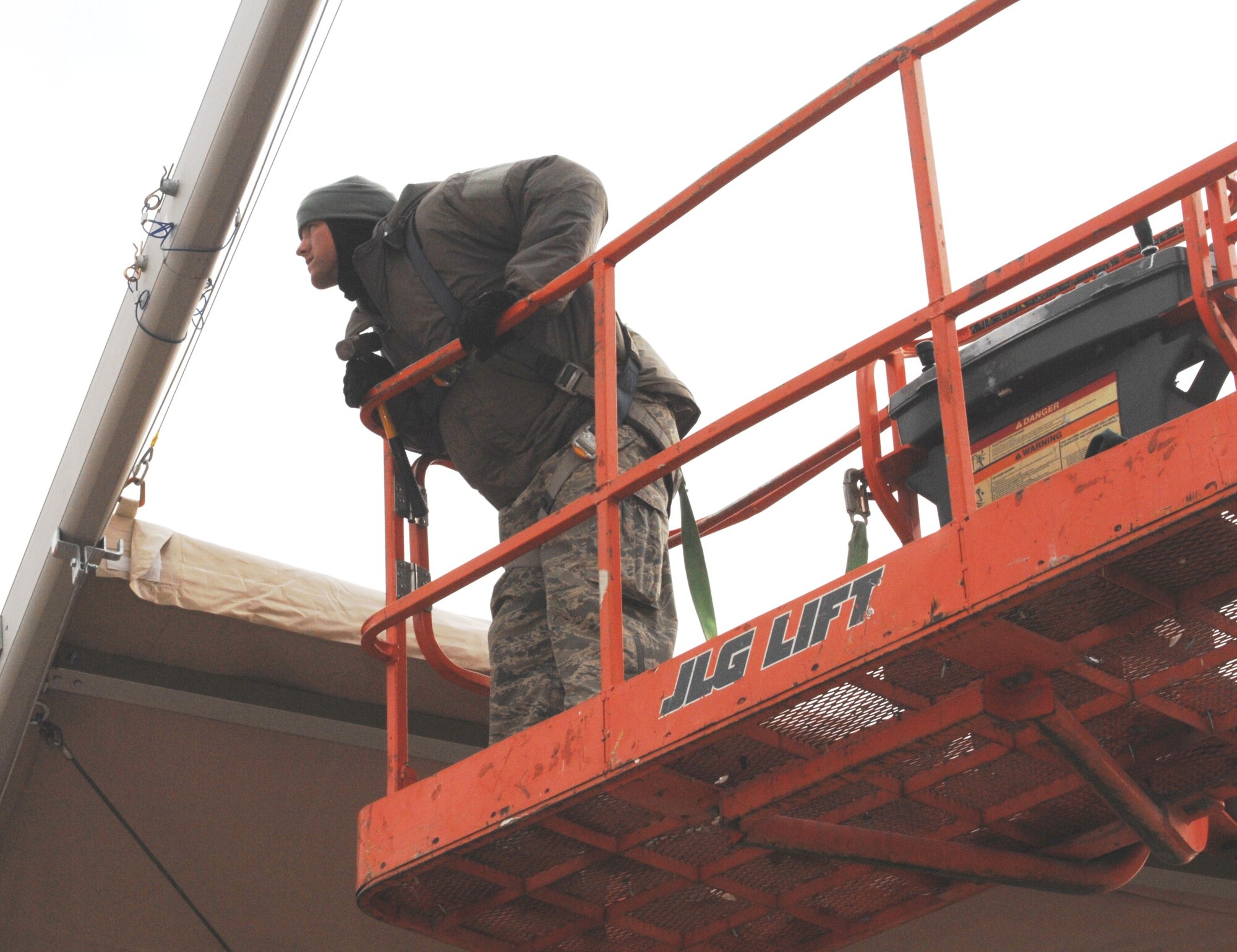 U.S. Air Force Staff Sgt. Joseph Dillard, J2 Basic Expeditionary Airfield Resources team, closely inspects a beam for a new 4K dome here Jan. 16, 2010. The tents will support the influx of Airmen, Soldiers, Sailors and Marines who pass through the Transit Center. The team, deployed from the 49th Material Maintenance Squadron, Holloman Air Force Base, N.M., travels the area of responsibility building structures. (U.S. Air Force photo/Senior Master Sgt. Mike Litsey/Released)