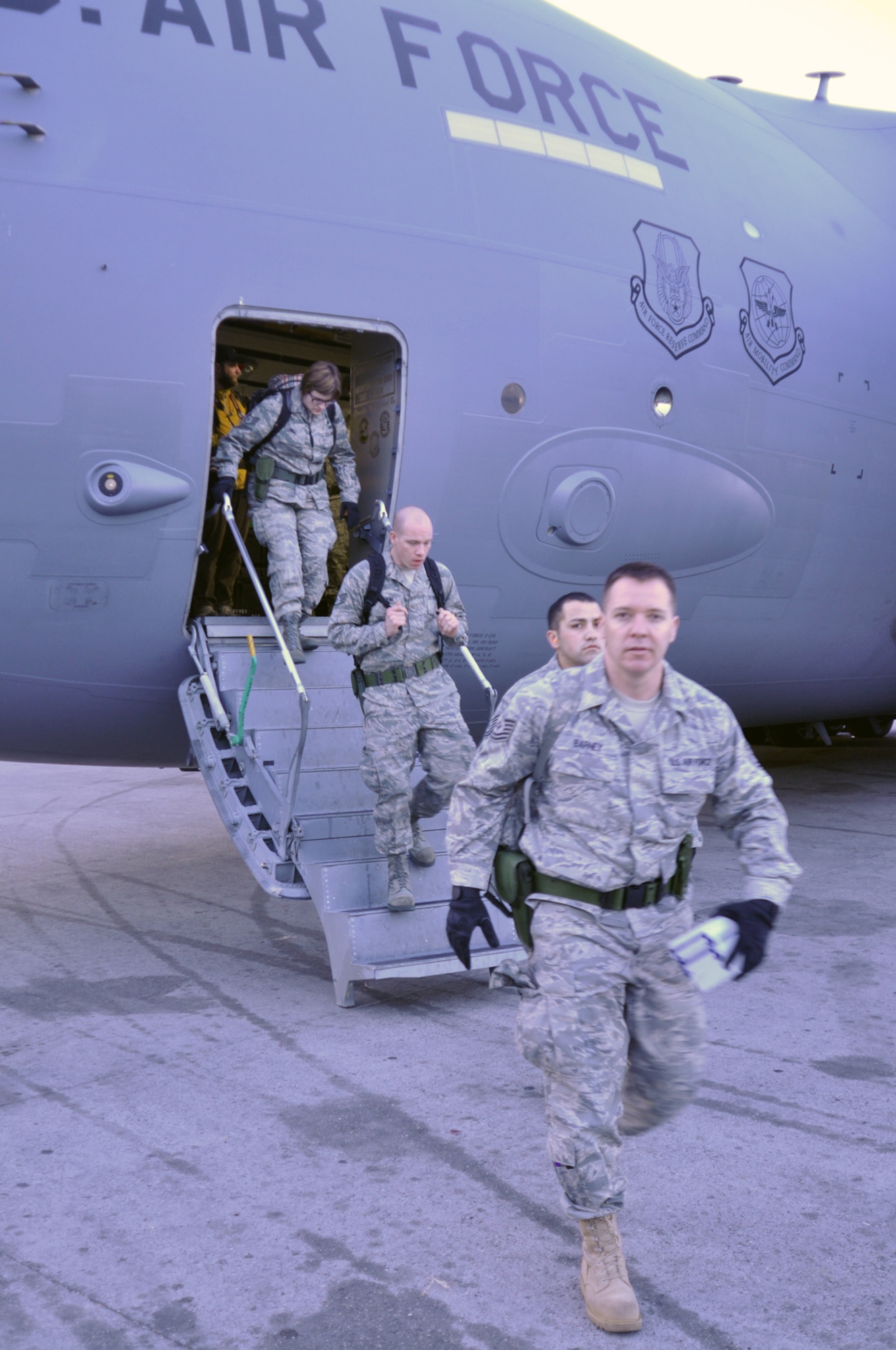 Members of the 419th Fighter Wing’s 67th Aerial Port Squadron step off a U.S. Air Force Reserve C-17 aircraft onto the tarmac at the Port-au-Prince airport Jan. 22. The group will be deployed there for at least 45 days. They will load and unload cargo and passengers from aircraft going in and out of Port-au-Prince as part of the massive multi-national relief effort underway there. (U.S. Air Force Photo/Kari Tilton)