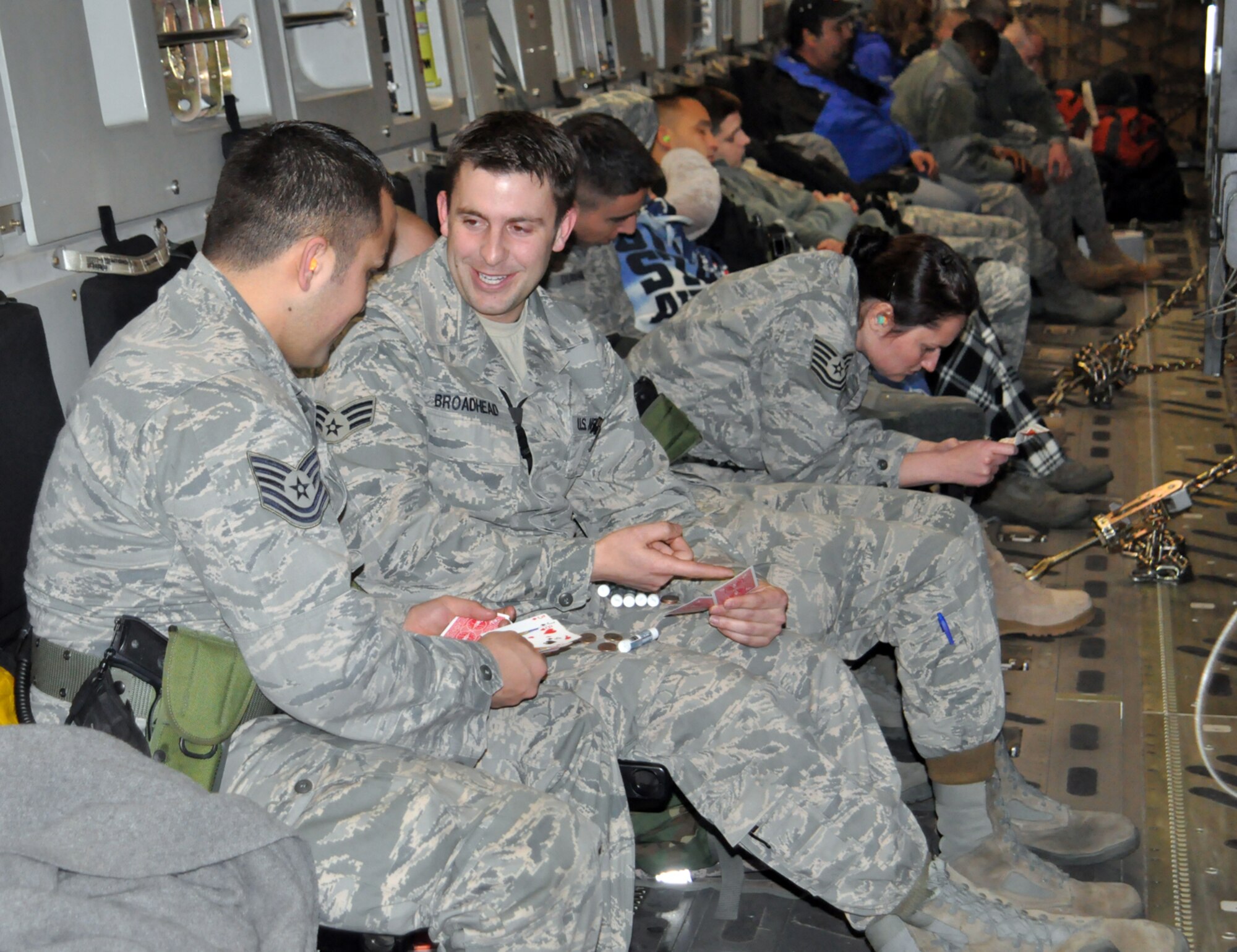 Senior Airman Sterling Broadhead and Tech. Sgt. Cody De Los Reyes play cards to help pass the time on the C-17 that landed in Port-au-Prince, Haiti Friday. They and 13 other reservists in the 419th Fighter Wing's 67th Aerial Port Squadron volunteered to assist in the humanitarian efforts there. (U.S. Air Force photo/Bryan Magaña)