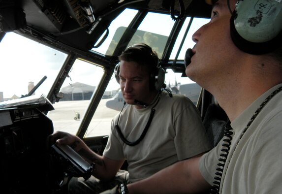 Tech. Sgts. Steven Pearson (foreground) and Walt Lee review readings from all four C-130 Hercules engines during a C-130 Hercules engine run Jan. 24 at Muniz Air Base, Puerto Rico. Both Sergeant Lee, an Air Force Reserve crew chief, and Sergeant Pearson, an Active Duty C-130 crew chief from the 52nd Airlift Squadron, performed the engine run to ensure maintenance performed on each engine earlier was correctly accomplished. Both sergeants are deployed to Puerto Rico from the Air Force Reserve's 302nd Airlift Wing in Colorado. The wing is currently assigned to the 35th Expeditionary Airlift Squadron, which supports Air Expeditionary Force Coronet Oak. The deployed members have also provided support to Haiti earthquake relief operations. (U.S. Air Force photo/Staff Sgt. Stephen J. Collier)