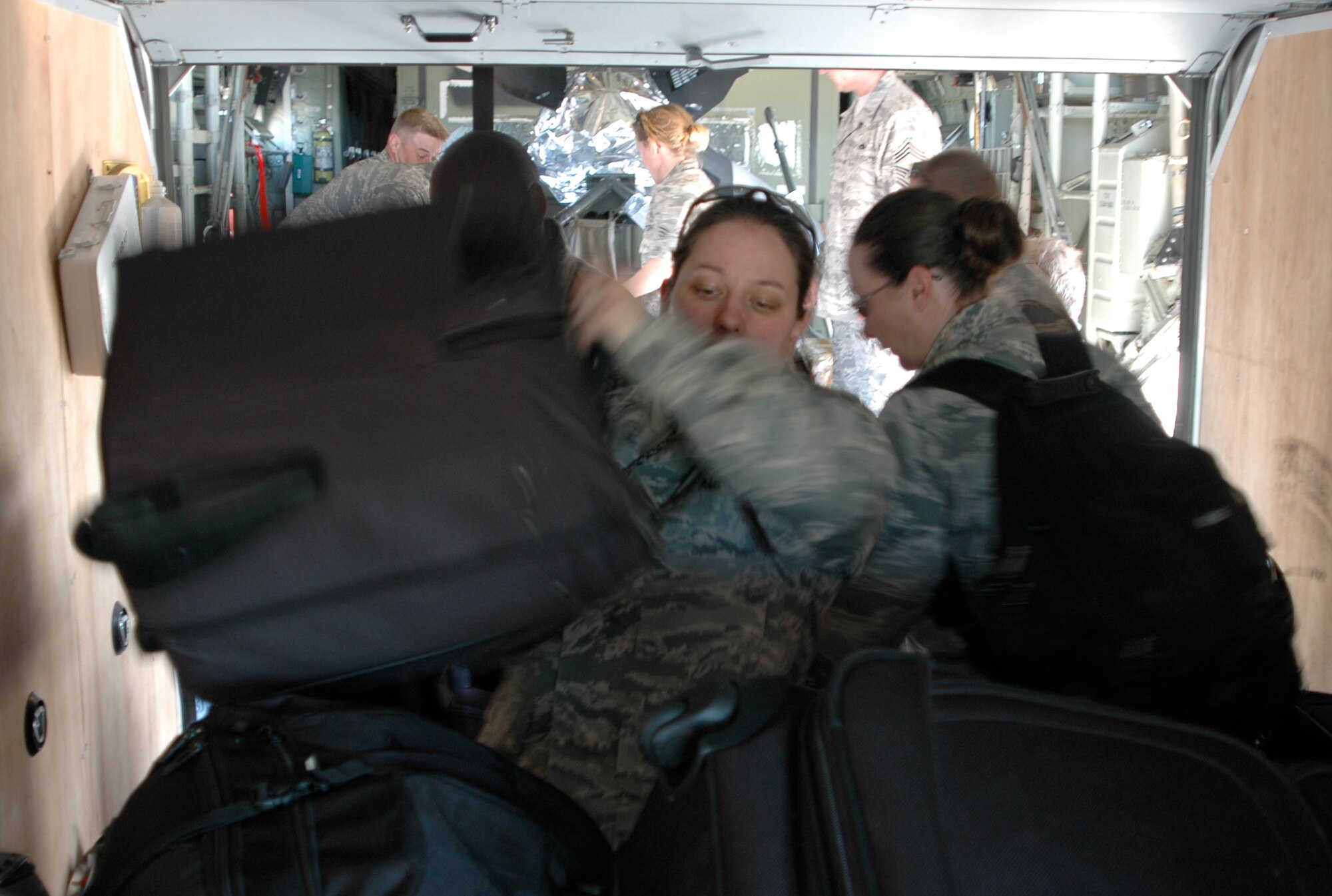 Staff Sgt. Gina Cerquozzi moves bag after bag of personal gear after she and members of the Air Force Reserve's 302nd Airlift Wing arrived Jan. 23 at Muniz Air Base, Puerto Rico. Approximately 50 Airmen from the 302nd AW are deployed to the U.S. territory in support of Air Expeditionary Force Coronet Oak and its involvement with earthquake relief operations in Haiti. The Colorado-based AF Reserve Airmen are expected to be at Muniz Air Base for two weeks, assigned to the 35th Expeditionary Airlift Squadron. Sergeant Cerquozzi is a avionics technicians from the 302nd Maintenance Squadron. (U.S. Air Force photo/Staff Sgt. Stephen J. Collier)