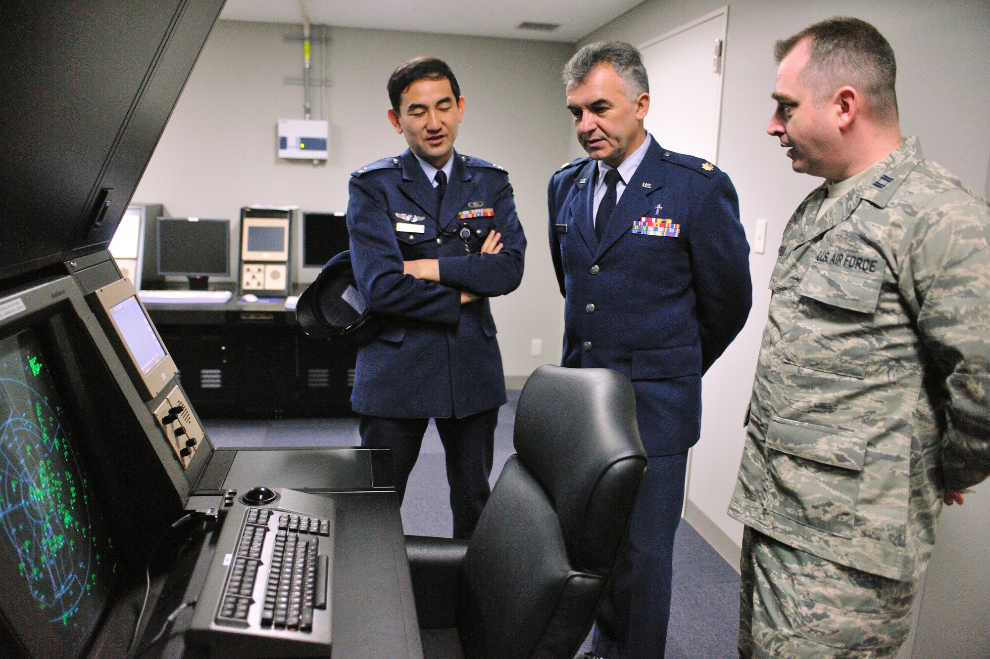 YOKOTA AIR BASE, Japan -- Capt. Todd Fairfield (right), 374th Operations Support Squadron Airfield Operations flight operations officer, explains Yokota's new Air Traffic Control facility operations to 374th Airlift Wing Chaplain (Maj) Jacek Kowalik the , Jan. 22. (U.S. Air Force photo/Osakabe Yasuo)
