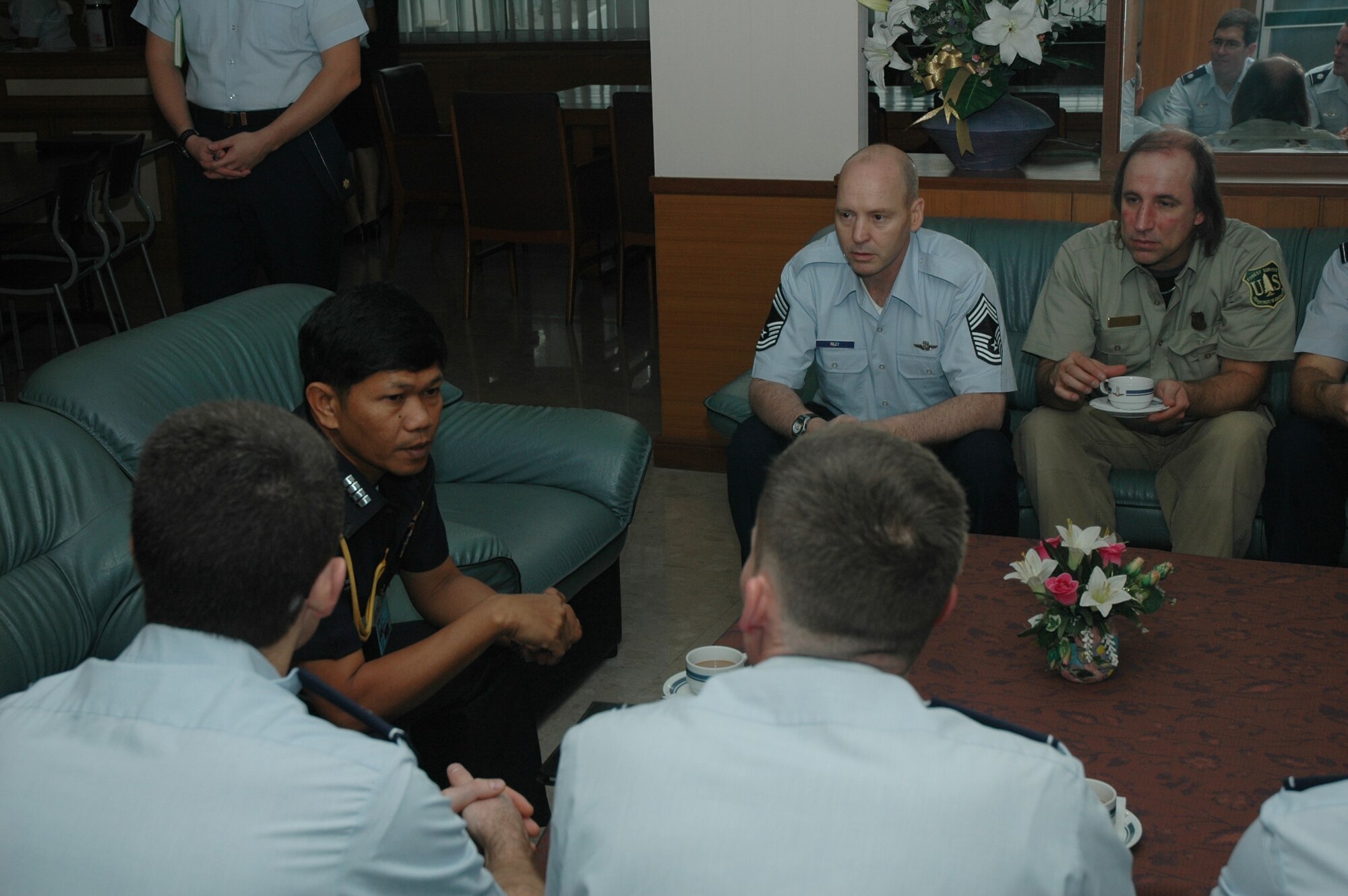Chief Master Sgt. James D. Riley, chief loadmaster with the Air Force Reserve’s 302nd Airlift Wing, listens to Group Captain Nimit Kraigratoke, deputy director, Special Task Division, Royal Thai Air Force discuss aerial firefighting in Thailand.  Seven members of the 302 AW traveled to Don Muang Royal Thai Air Force Base, Thailand to provide expert training to RTAF members on safe and effective Modular Airborne Firefighting System operations.  This event marks the first time the Air Force Reserve has sent delegates to train a foreign Air Force on use of the MAFFS equipment.  Accompanying the Air Force Reserve contingent is Mr. David P. Stickler, leadplane and instructor pilot with the U.S. Forest Service. (U.S. Air Force photo/Capt. Jody L. Ritchie)