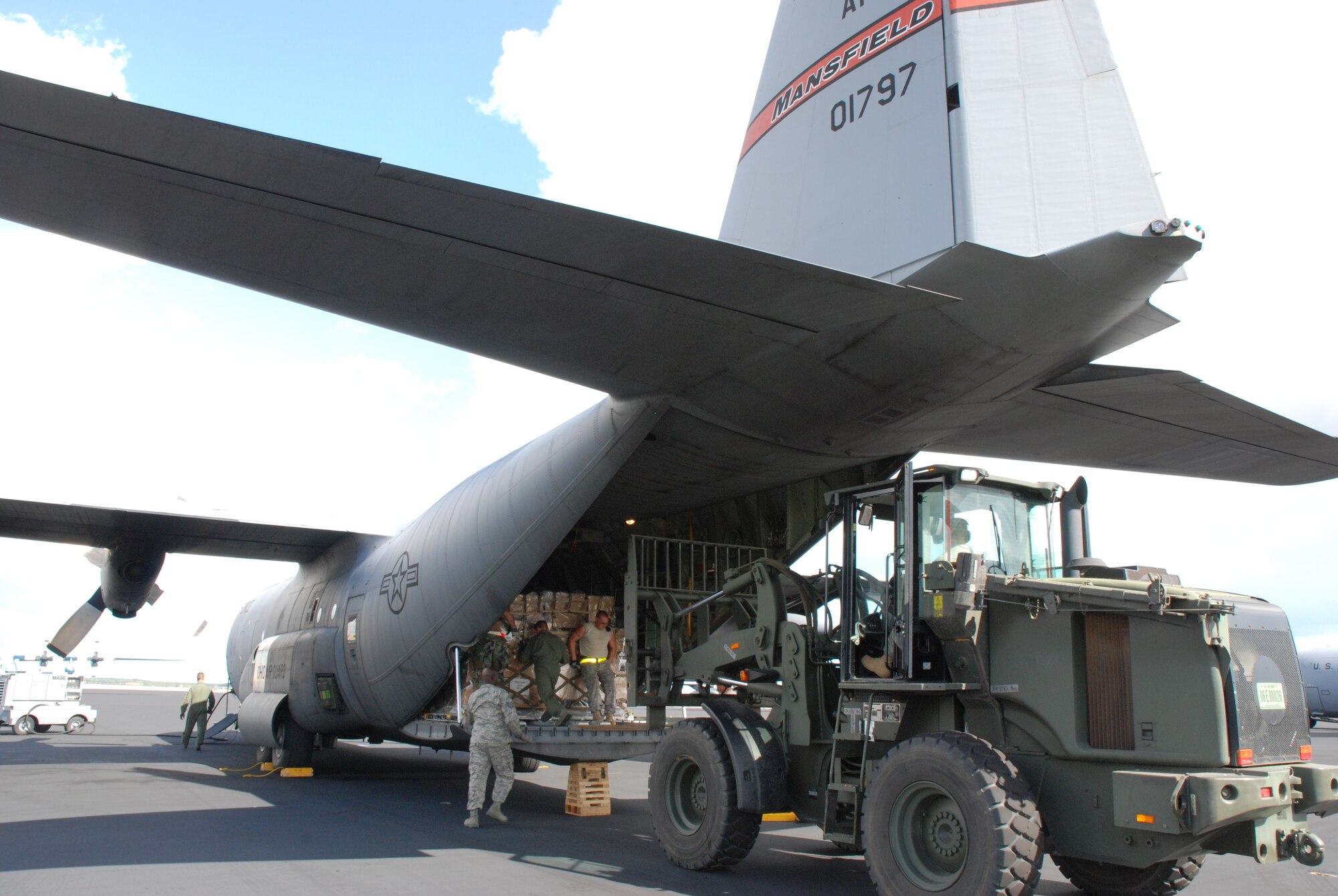 Guardsmen, reservists and active duty Airmen load cargo on a C-130 at Homestead Air Reserve Base, Fla. The C-130 is assigned to the 35th Expeditionary Airlift Squadron which provides the command and control for Coronet Oak missions into Central and South America. 
The cargo was loaded for delivery to military forces in the Dominican Republic assisting with the earthquake relief in Haiti. The cargo consisted of bottled water, medical supplies and other needed items. Ohio Air National Guard C-130s out of Mansfield provided the first military airlift into Haiti in support of Operation Unified Response. (U.S. photo by Master Sgt. Stan Coleman)
