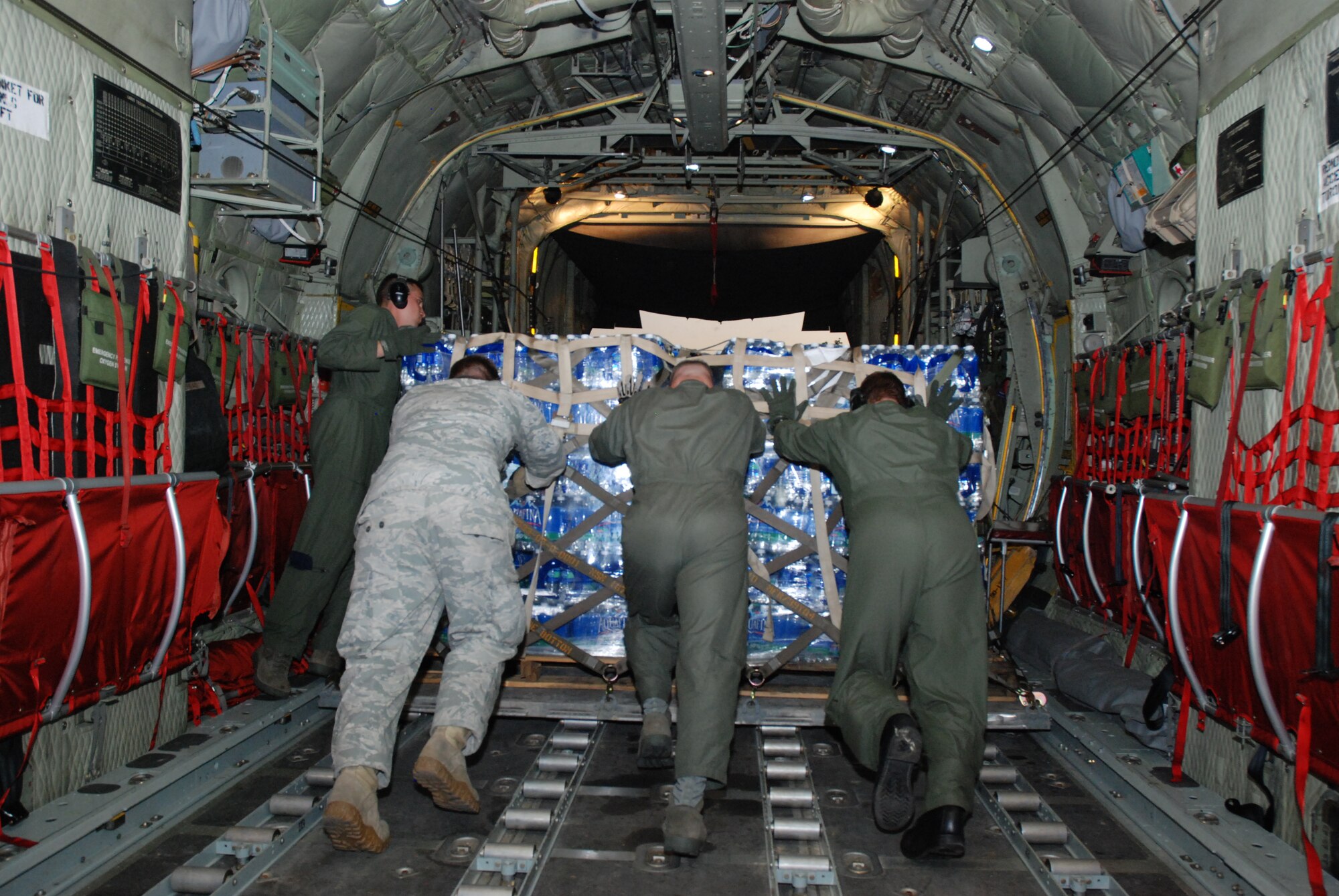 Air Force reservists, Guardsmen and active duty Airmen assist with
off-loading a pallet of water delivered to the Dominican Republic on Jan.
22. The water was delivered in support of the earthquake victims of Haiti.
The 35th Expeditionary Airlift Squadron Operations team coordinated airlift
movement from Muñiz Air National Guard Base. (U.S. Air Force photo/Master Sgt.
Stan Coleman)