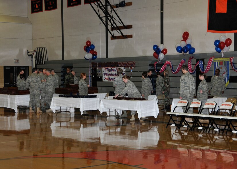 Members of the 131st Bomb Wing set up the decorations for the Hometown Heroes Salute ceremony at Ritenour High School Jan. 23. More than 200 Airmen were honored during the ceremony for their outstanding support during deployments in support of Operations Enduring Freedom, Iraqi Freedom and Noble Eagle. (Photo by Master Sgt. Mary-Dale Amison)