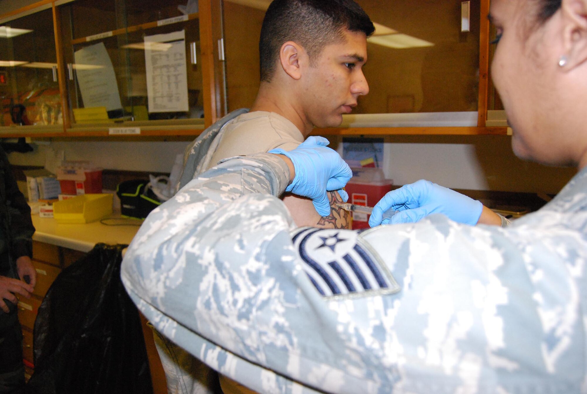 Members of the 433rd Medical Squadron administer the H1N1 immunization to fellow reservists during the B Unit Training Assembly. This immunization is mandatory for all uniformed members, If you haven't recieved yours, get with your Unit Health Monitor. (U.S. Air Force photo by Senior Airman Viola M Hernandez)