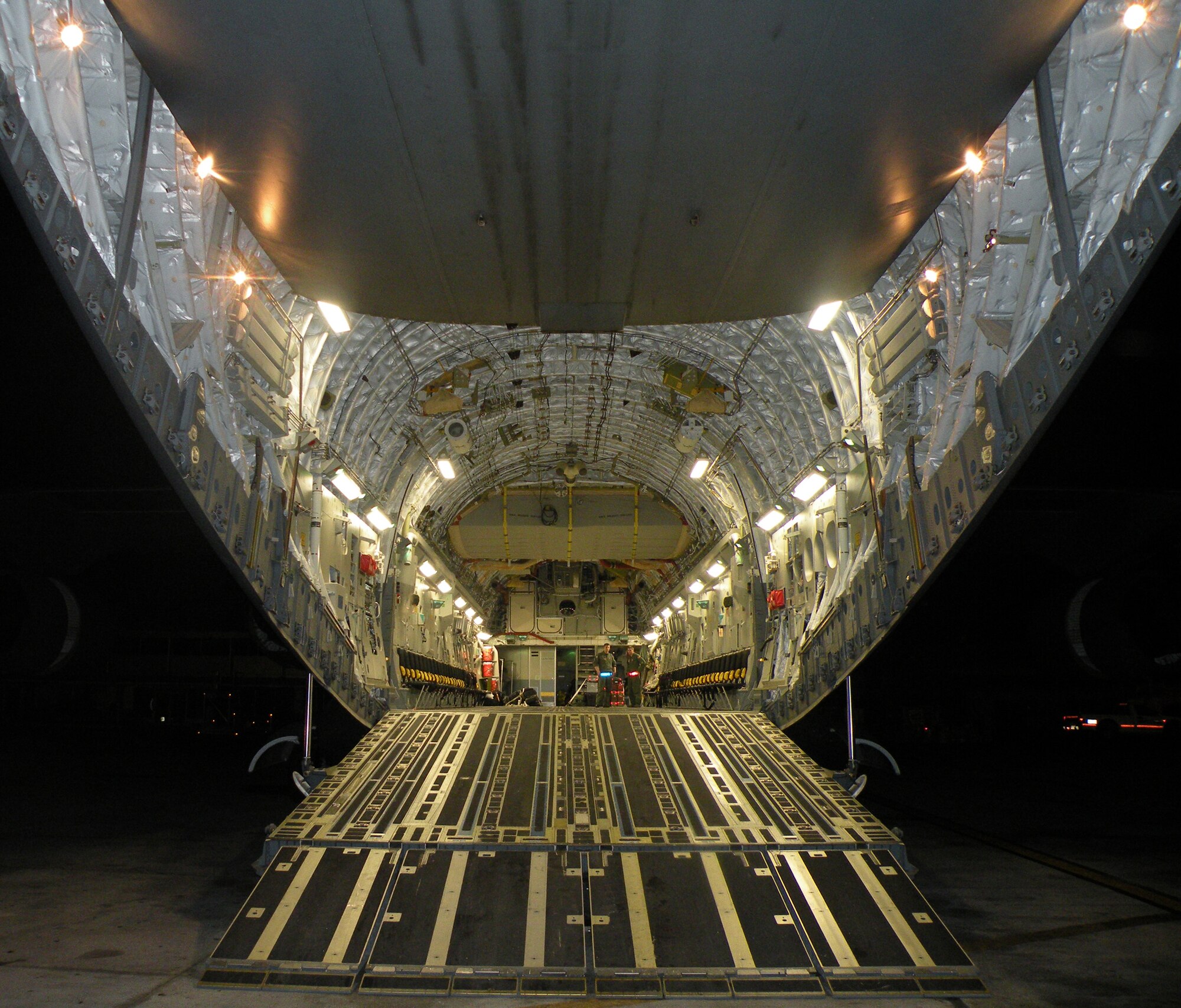 Staff Sgts. Steve Pinkerton and Gus Morse, Reserve loadmasters from the 317th Airlift Squadron, Charleston Air Force Base, S.C., stand inside a C-17 Globemaster III that just landed in Haiti in support of Operation Unified Response during the early morning hours of Jan. 22, 2010. (U.S. Air Force Photo/Master Sgt. Steve Staedler)                              