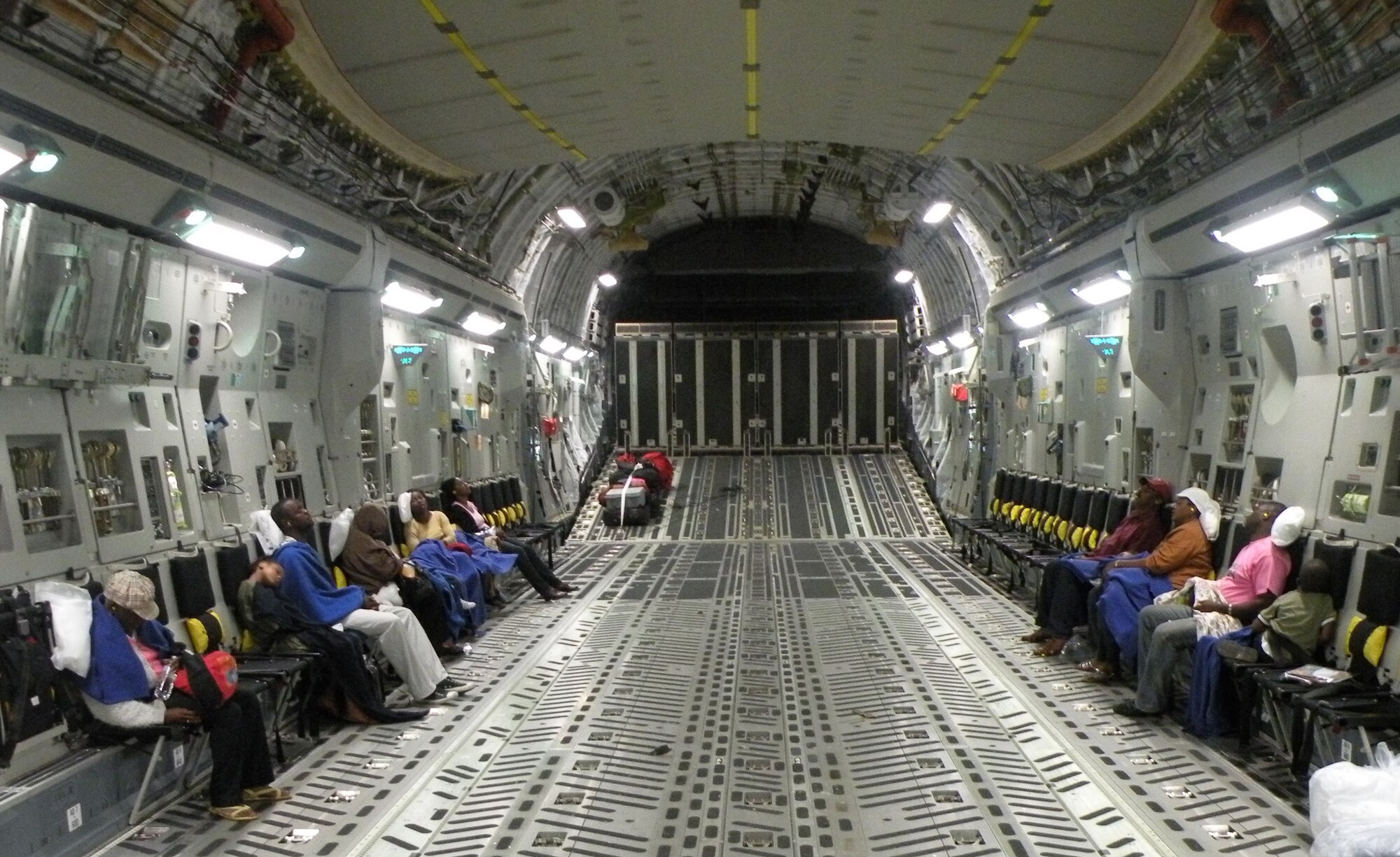 Sixteen Haitian passengers are fast asleep minutes after takeoff on a C-17 Globemaster III from Haiti enroute to Orlando during the early morning hours of Jan. 22, 2010. The Travis Air Force Base, Calif.-based aircraft was flown by Reservists from the 317th Airlift Squadron, Charleston AFB, S.C. (U.S. Air Force Photo/Master Sgt. Steve Staedler)                                         