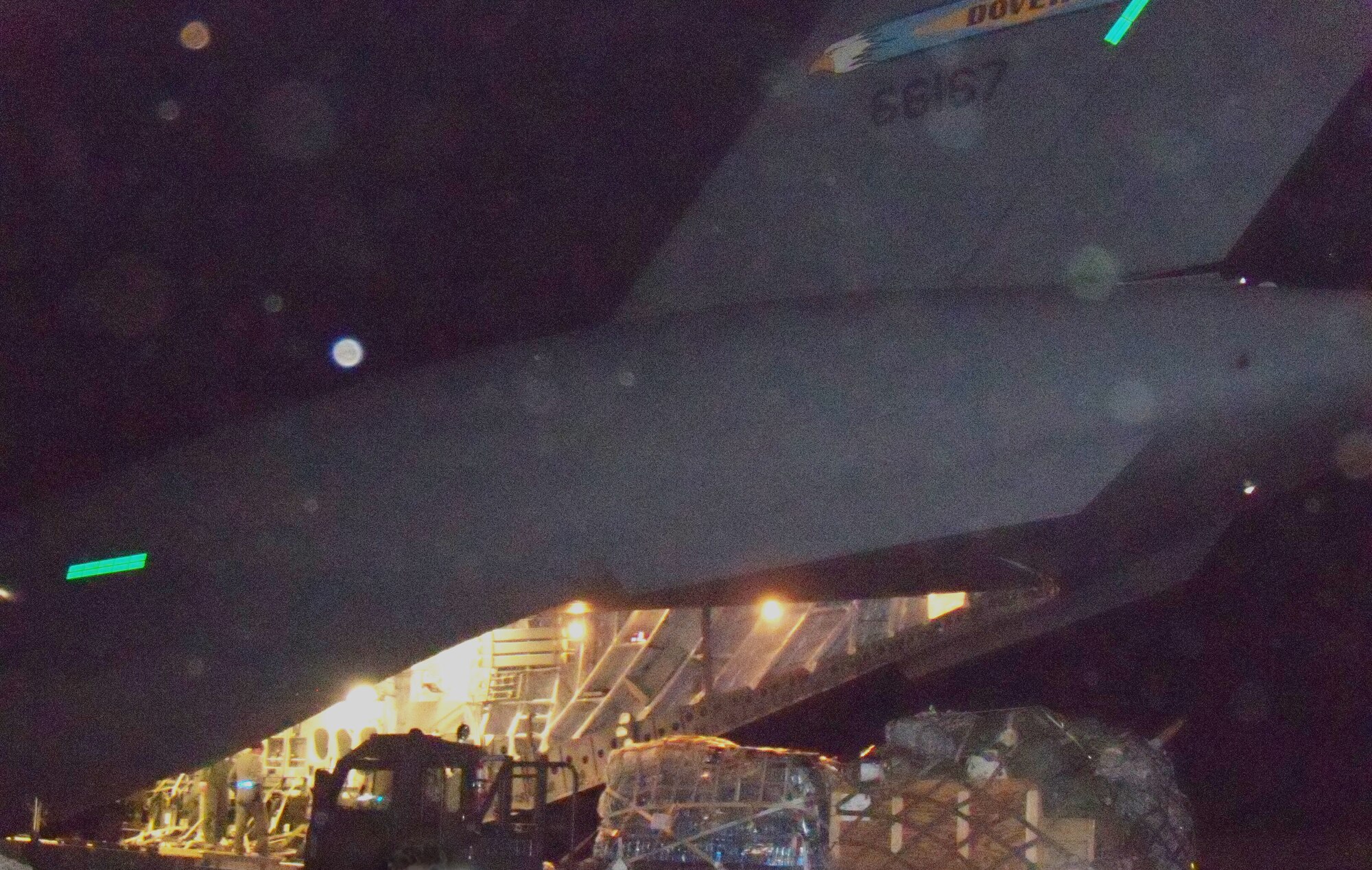 A C-17 Globemaster III from the 3rd Airlift Squadron drops off 90,000 pounds of disaster relief aid at the Port-au-Prince airport in Haiti on Jan. 19 in support of Operation Unified Response. After unloading all the cargo, they loaded 36 evacuees and brought them into the United States. (U.S. photo/2d Lt. Abigail Wise)          
