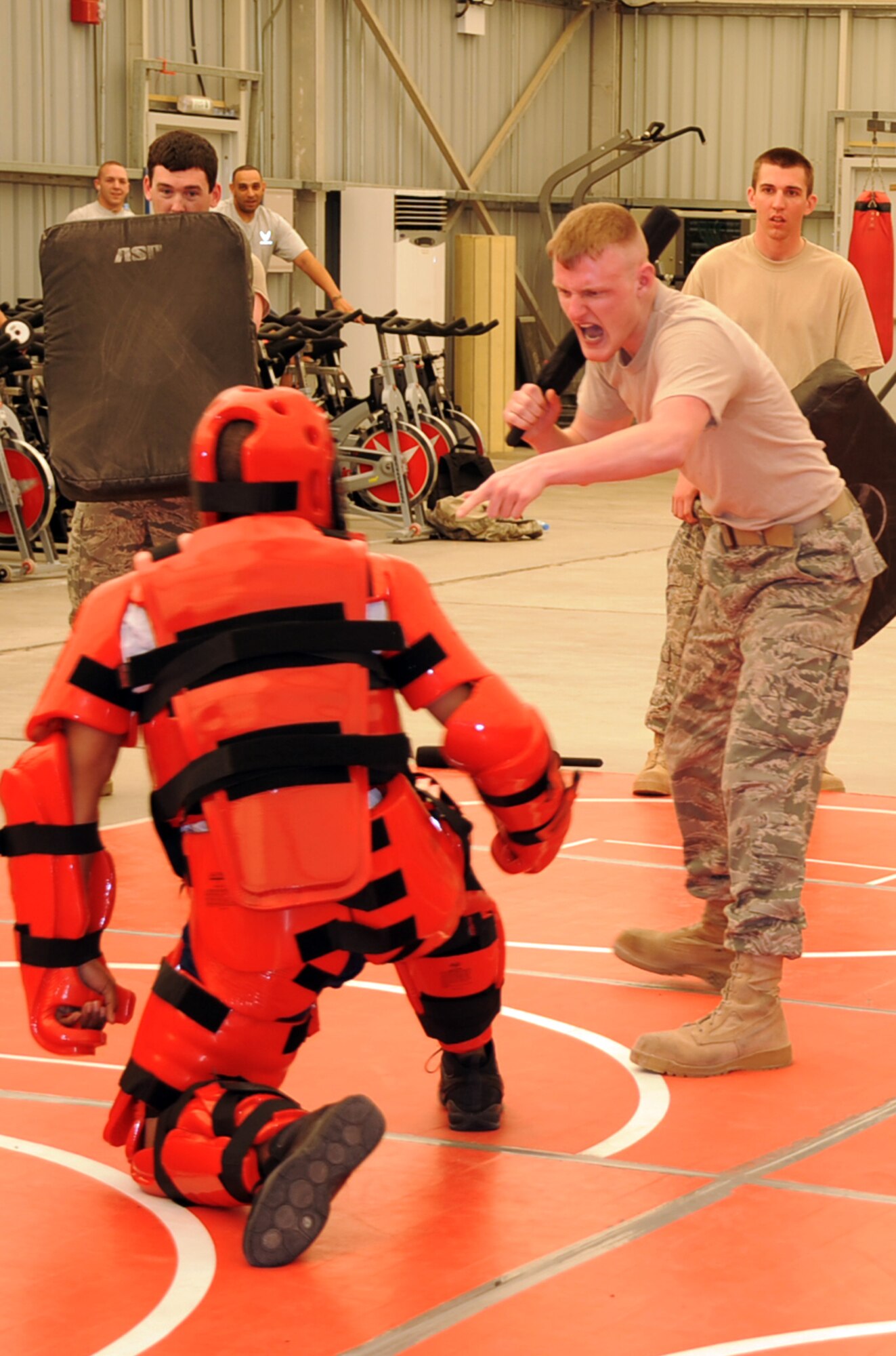 Senior Airman Gary Voltz, deployed with the 380th Air Expeditionary Wing as a force protection Airman, learns techniques to use a baton during training at a non-disclosed location in Southwest Asia on Jan. 22, 2010. Security forces Airmen were training force protection Airmen on baton certification with the security forces wearing a protective "red man" suit acting as agressors. During the training, they used simulated batons to learn the tactics, techniques and procedures for the use of batons. Security forces Airmen receive training such as this at regional training centers such as the U.S. Air Force Expeditionary Center at Joint Base McGuire-Dix-Lakehurst, N.J., in courses such as the Phoenix Warrior Training Course and the Phoenix Raven Training Course. Airman Voltz is deployed from the 9th Aircraft Maintenance Squadron at Beale Air Force Base, Calif., and his hometown is Kenosha. Wisc. (U.S. Air Force Photo/Tech. Sgt. Scott T. Sturkol/Released)