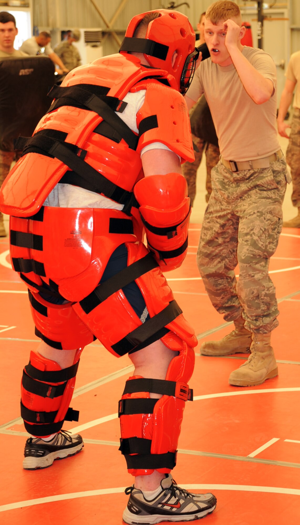 Senior Airman Gary Voltz, deployed with the 380th Air Expeditionary Wing as a force protection Airman, learns techniques to use a baton during training at a non-disclosed location in Southwest Asia on Jan. 22, 2010. Security forces Airmen were training force protection Airmen on baton certification with the security forces wearing a protective "red man" suit acting as agressors. During the training, they used simulated batons to learn the tactics, techniques and procedures for the use of batons. Security forces Airmen receive training such as this at regional training centers such as the U.S. Air Force Expeditionary Center at Joint Base McGuire-Dix-Lakehurst, N.J., in courses such as the Phoenix Warrior Training Course and the Phoenix Raven Training Course. Airman Voltz is deployed from the 9th Aircraft Maintenance Squadron at Beale Air Force Base, Calif., and his hometown is Kenosha. Wisc. (U.S. Air Force Photo/Tech. Sgt. Scott T. Sturkol/Released)