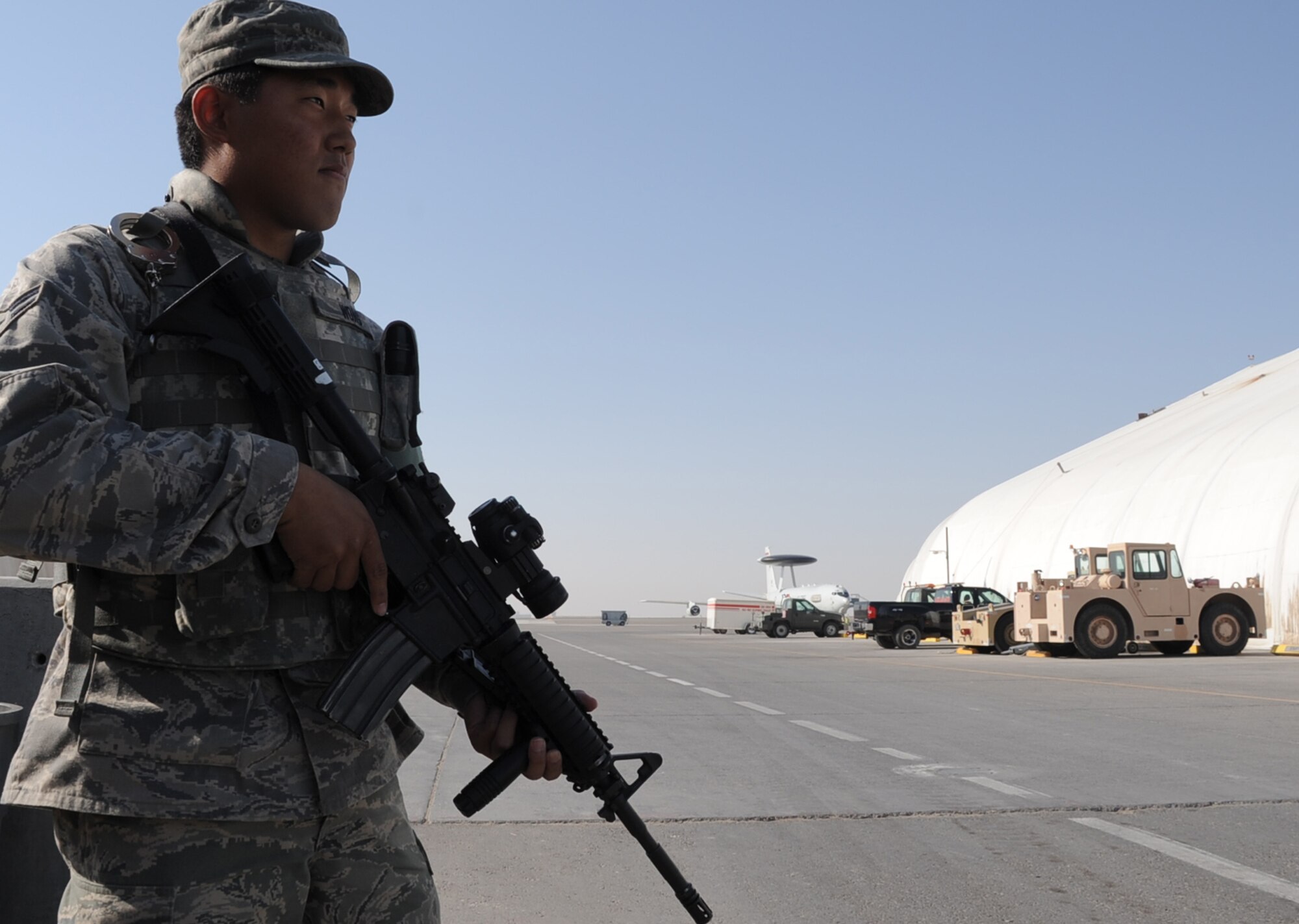 Airman 1st Class Brandon Wong, security forces journeyman with the 380th Expeditionary Security Forces Squadron at a non-disclosed base in Southwest Asia, watches over a checkpoint during operations near the flightline Jan. 22, 2010.  Airman Wong is deployed from the 47th Security Forces Squadron at Laughlin Air Force Base, Texas, and his hometown is Kapolei, Hawaii.  (U.S. Air Force Photo/Tech. Sgt. Scott T. Sturkol/Released)