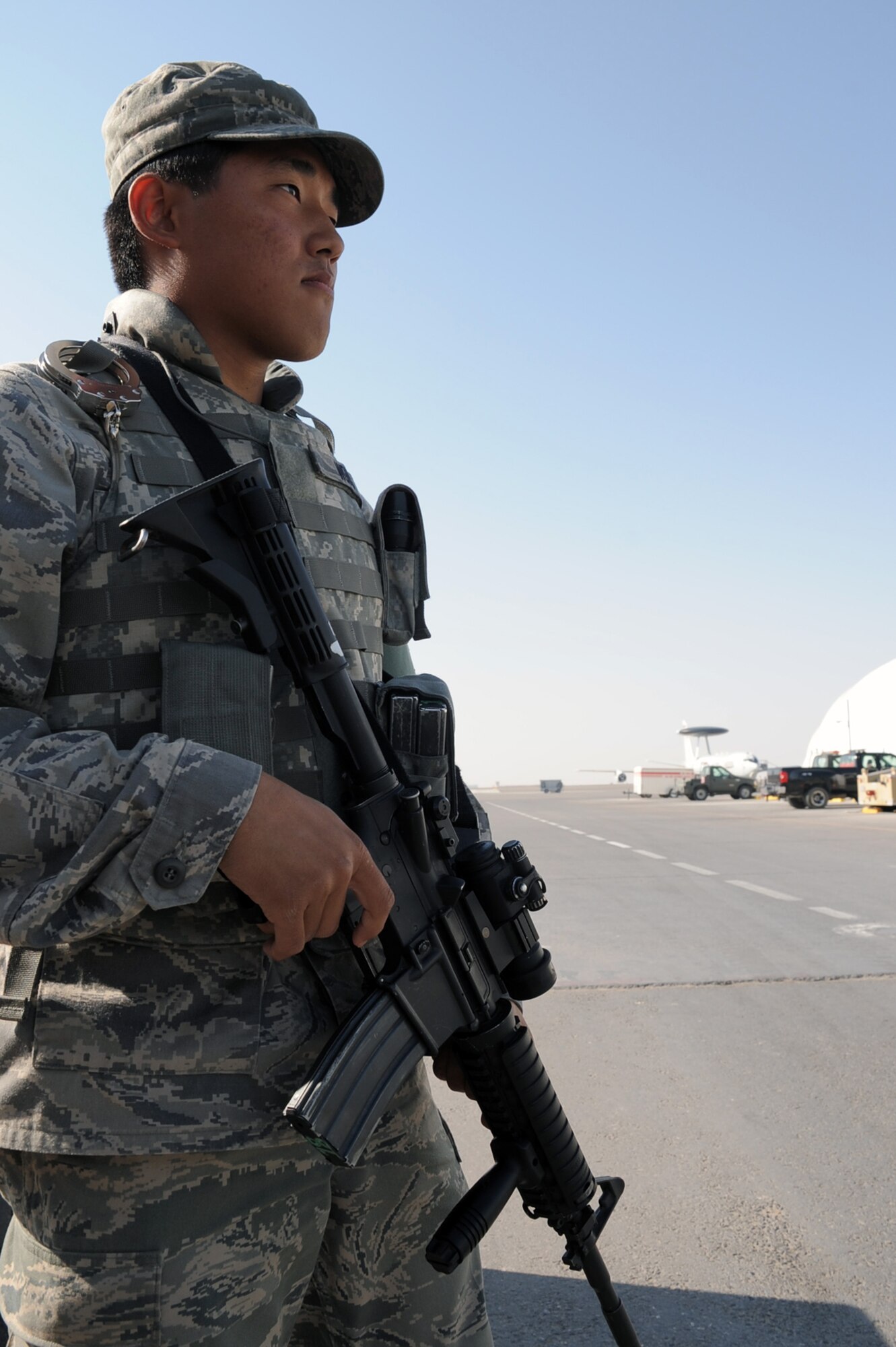 Airman 1st Class Brandon Wong, security forces journeyman with the 380th Expeditionary Security Forces Squadron at a non-disclosed base in Southwest Asia, watches over a checkpoint during operations near the flightline Jan. 22, 2010.  Airman Wong is deployed from the 47th Security Forces Squadron at Laughlin Air Force Base, Texas, and his hometown is Kapolei, Hawaii.  (U.S. Air Force Photo/Tech. Sgt. Scott T. Sturkol/Released)