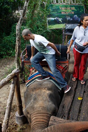 A Marine boards an elephant staged at the loading deck during the Single Marine Program trip to Haew Suwat Waterfalls in the Khao Yai National Park in Thailand Jan. 24. Three Marines were allowed per elephant to trek through the jungle.