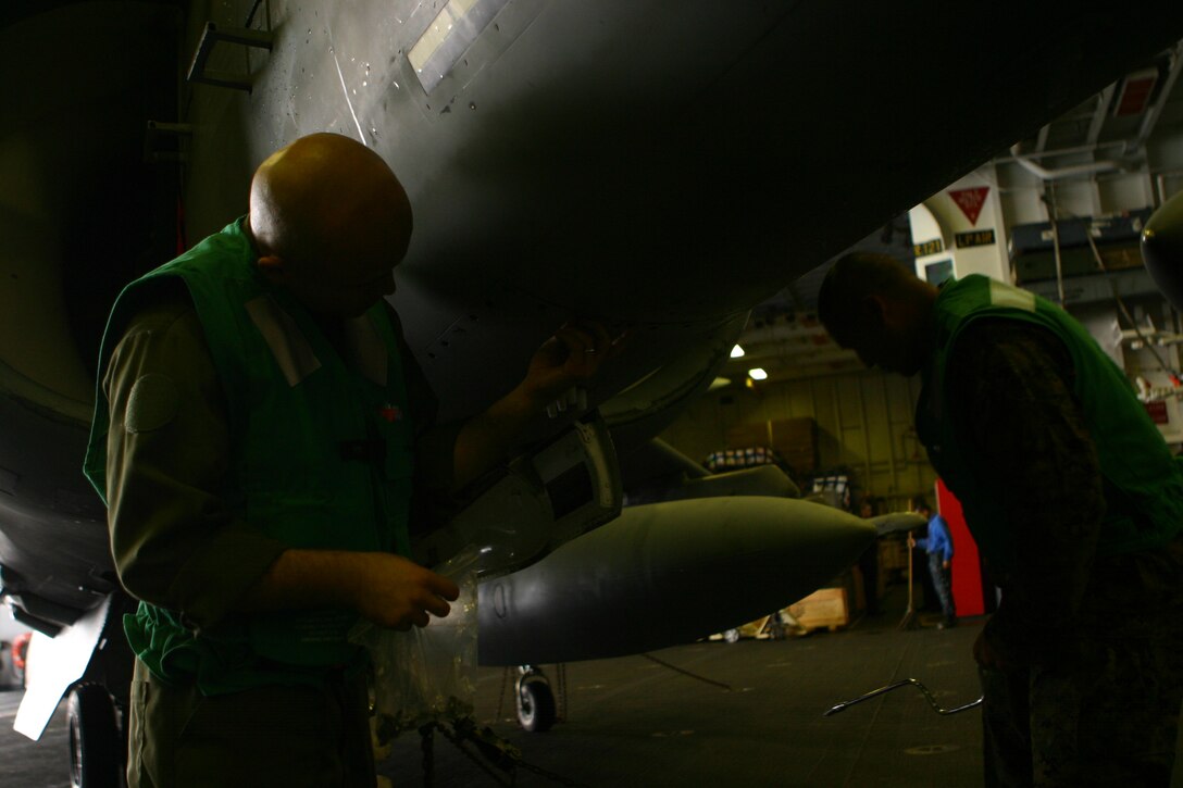 Sgt. David Camacho Jr. (left), an AV-8B Harrier jet airframe mechanic from Marine Attack Squadron 311 (VMA-311), 31st Marine Expeditionary Unit (MEU), performs maintenance on a harrier in the hangar bay aboard the forward-deployed amphibious assault ship USS Essex (LHD 2), Jan. 25. The MEU is currently scheduled to head to the Kingdom of Thailand in support of Exercise Cobra Gold 2010 (CG ’10). CG’10 is the latest in a continuing series of exercises designed to promote regional peace and security.