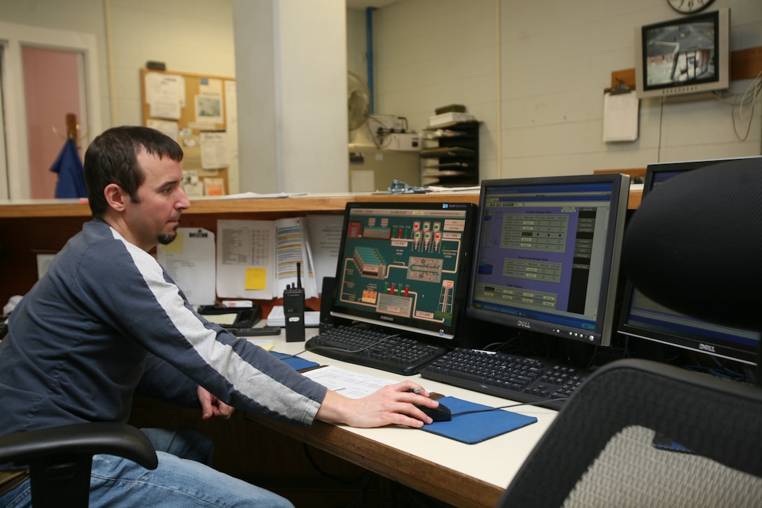 Rob Godwin, a water treatment plant operator at Cherry Point’s water treatment plant, monitors the plant’s activities on the main computer. Boiler plant operators must make sure that the facility is working properly 24 hours a day 365 days a year.