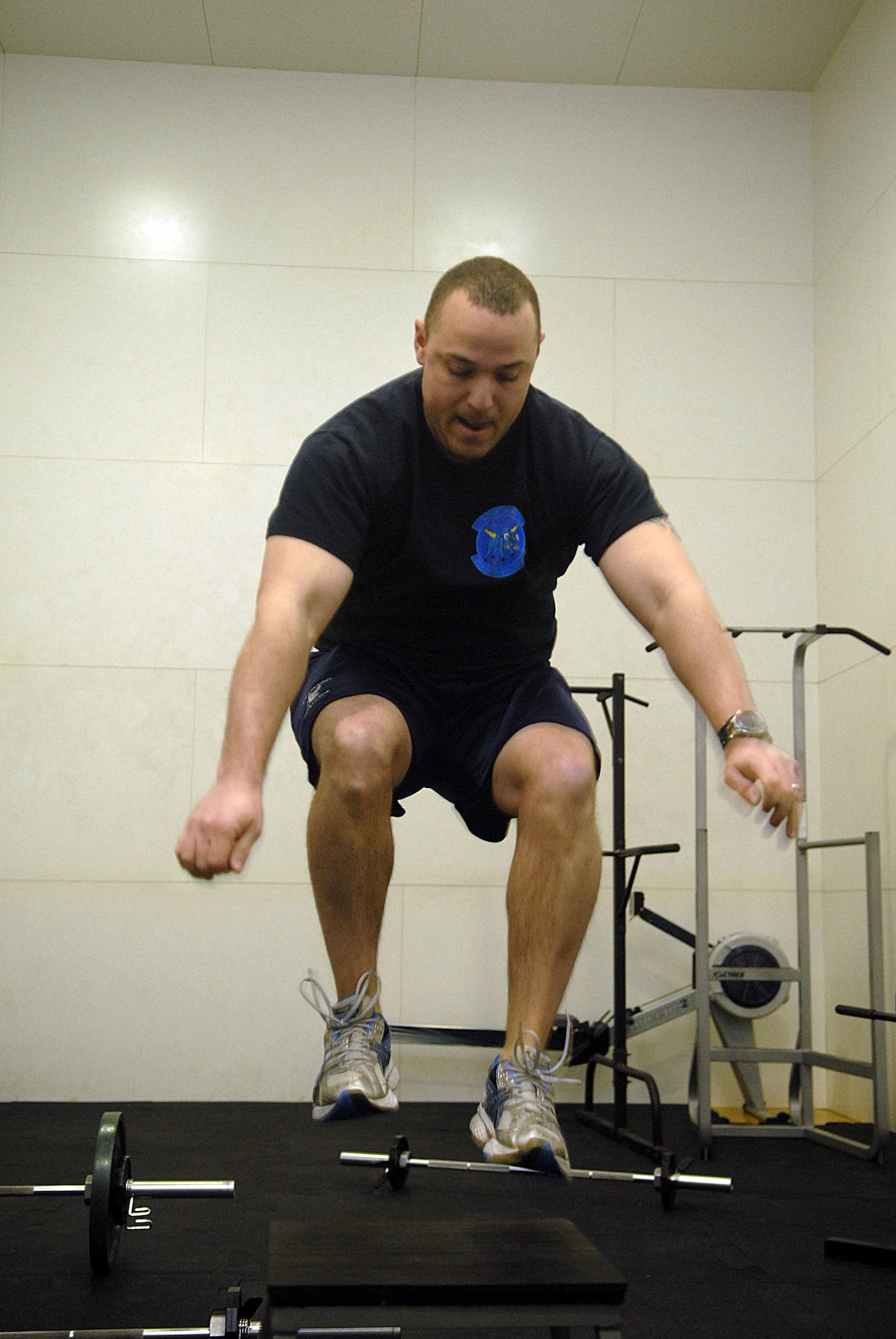 KUNSAN AIR BASE, Republic of Korea -- Capt. Brian Lassiter, 8th Civil Engineer Squadron, jumps up on a box during a CrossFit work out at the fitness Center Jan. 23. CrossFit's purpose is to move large loads over long distances, and to do so quickly. (U.S. Air Force photo/Senior Airman Roy Lynch)
