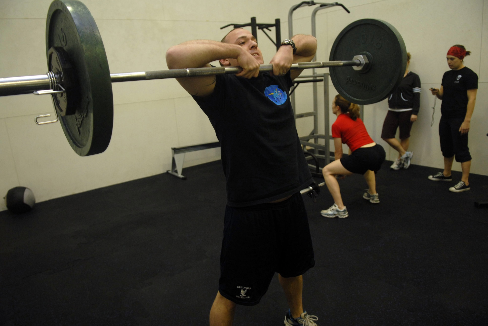 KUNSAN AIR BASE, Republic of Korea -- Capt. Brian Lassiter, 8th Civil Engineer Squadron, performs a Sumo Dead Lift High Pull during a CrossFit work out at the fitness Center Jan. 23. CrossFit's purpose is to quickly move large loads over long distances. The first fitness assessment and fundamental class begins Jan. 30 from 10 a.m. to 1 p.m. at the fitness center. (U.S. Air Force photo/Senior Airman Roy Lynch)