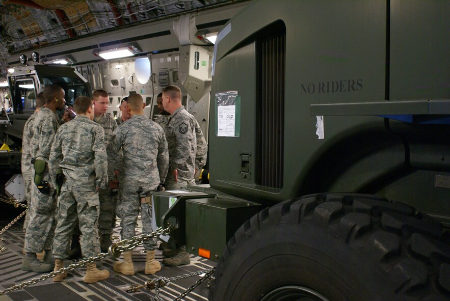 62nd Aerial Port Squadron Airmen de-brief just after arriving in Port-Au-Prince, Haiti Friday as part of a 15-Airmen APS team deployed to the island in support of relief operations. All the Airmen deployed to Haiti volunteered in addition to their normal deployment rotation. They are scheduled to be there for as long as 60 days, working up to 18 hours each day in the tropical heat. (U.S. Air Force photo/Senior Airman Kirsten Wicker)