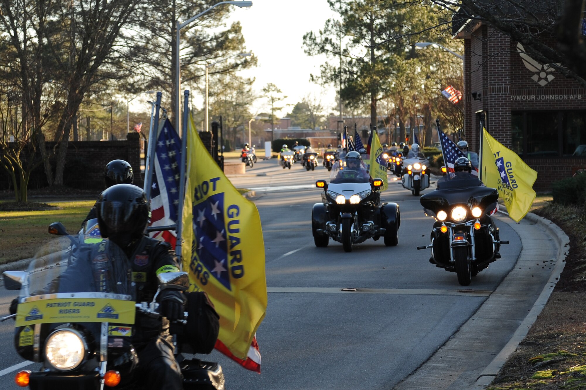 Members of the Patriot Guard Riders escort Tech. Sgt. Adam Ginett, a fallen explosive ordnance disposal technician, off Seymour Johnson Air Force Base, N.C., after a dignified transfer ceremony Jan. 25, 2010. More than 80 riders participated in the escort. Ginett, a Knightdale, N.C., native was assigned to the 31st Civil Engineer Squadron EOD flight at Aviano Air Base, Italy. (U.S. Air Force photo/Master Sgt. Brandt Smith)