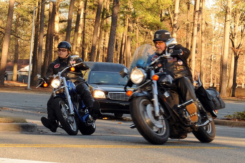 Members of the Patriot Guard Riders escort Tech. Sgt. Adam Ginett following a dignified transfer ceremony on Seymour Johnson Air Force Base, N.C., Jan. 25, 2010. Patriot Guard Riders serve as a barrier around mourning family and friends. They prevent interruptions during military funerals when invited by families. (U.S. Air Force photo/Senior Airman Whitney Lambert)