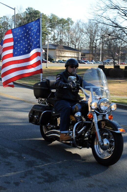David Cantara, Army veteran and Patriot Guard Rider, escorts Tech. Sgt Adam Ginett, explosive ordinate disposal, following a dignified transfer ceremony on Seymour Johnson Air Force Base, N.C., Jan. 25, 2010. Ginett, a Knightdale, N.C., native, died of wounds suffered from an improvised explosive device near Kandahar Air Field, Afghanistan, Jan. 19. (U.S. Air Force photo/Senior Airman Whitney Lambert)