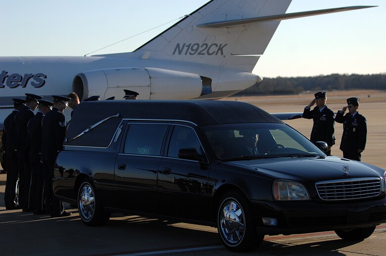 Col. Mark Kelly, 4th Fighter Wing commander, and Lt. Col. William Mazzeno, 4th Civil Engineer Squadron commander, salute Tech. Sgt. Adam Ginett, a fallen explosive ordnance disposal technician, during a dignified transfer ceremony on Seymour Johnson Air Force Base, N.C., Jan. 25, 2010. Ginett, a Knightdale, N.C., native, died of wounds suffered from an improvised explosive device near Kandahar Air Field, Afghanistan, Jan. 19. (U.S. Air Force photo/Senior Airman Ciara Wymbs)
