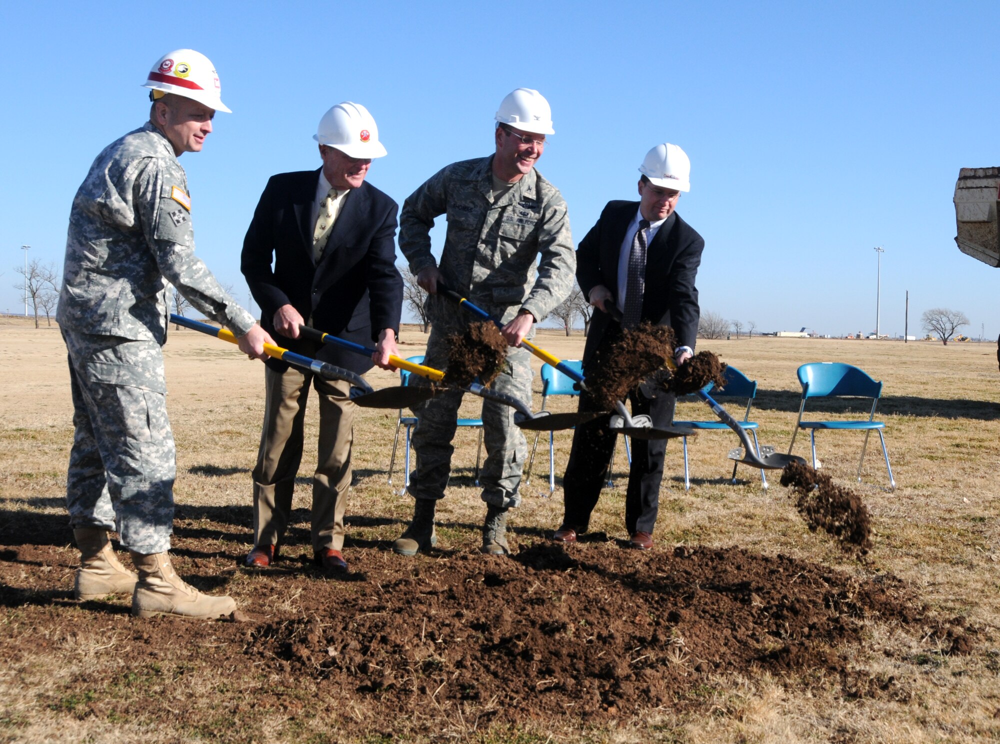 ALTUS AIR FORCE BASE, Okla—(From left) Army Col. Tony Funkhouser, commander of the Tulsa District Corps of Engineers, Col. Ty Thomas, commander of the 97th Air Mobility Wing, Jim Inhofe, U.S. senator, and David Scott, SGS representative, shovel the first bit of dirt where the new  radar approach control facility will be built Jan.22. This facility will house the state- of -the art digital aircraft surveillance radar that will offer better capability to air traffic controllers base and throughout southwest Oklahoma. The construction will cost $7.1 million and will be completed in April 2011. The new radar will replace the 1970s-era systems currently in use. (U.S. Air Force photo/Senior Airman Cherice Bryant)
