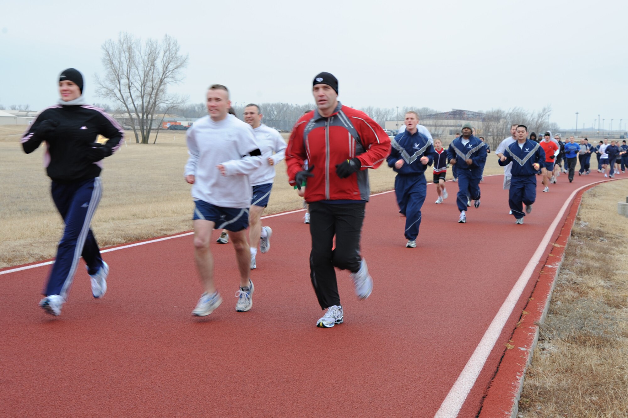 Team McConnell members run their first lap around the running track, during a 5K fun-run, Jan. 21, 2010, at McConnell Air Force Base, Kan. The run was open to McConnell members and their families to boost morale and participate in group exercise. (U.S. Air Force Photo/Senior Airman Ruiz)
